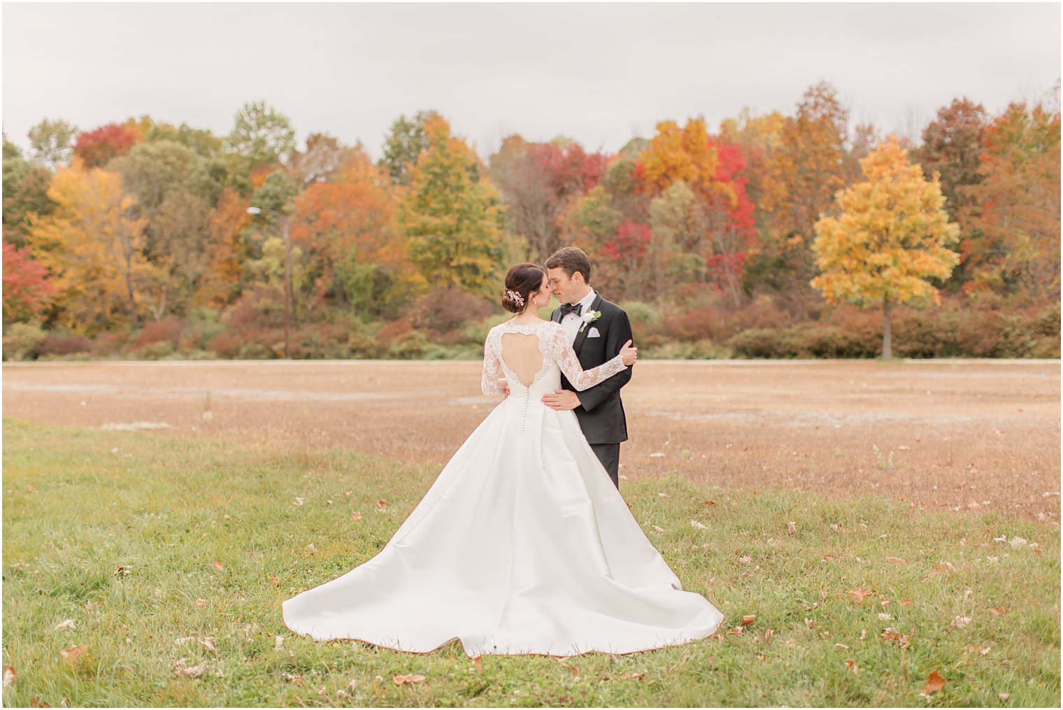groom holds bride during fall Conservatory at the Sussex County Fairgrounds wedding photos