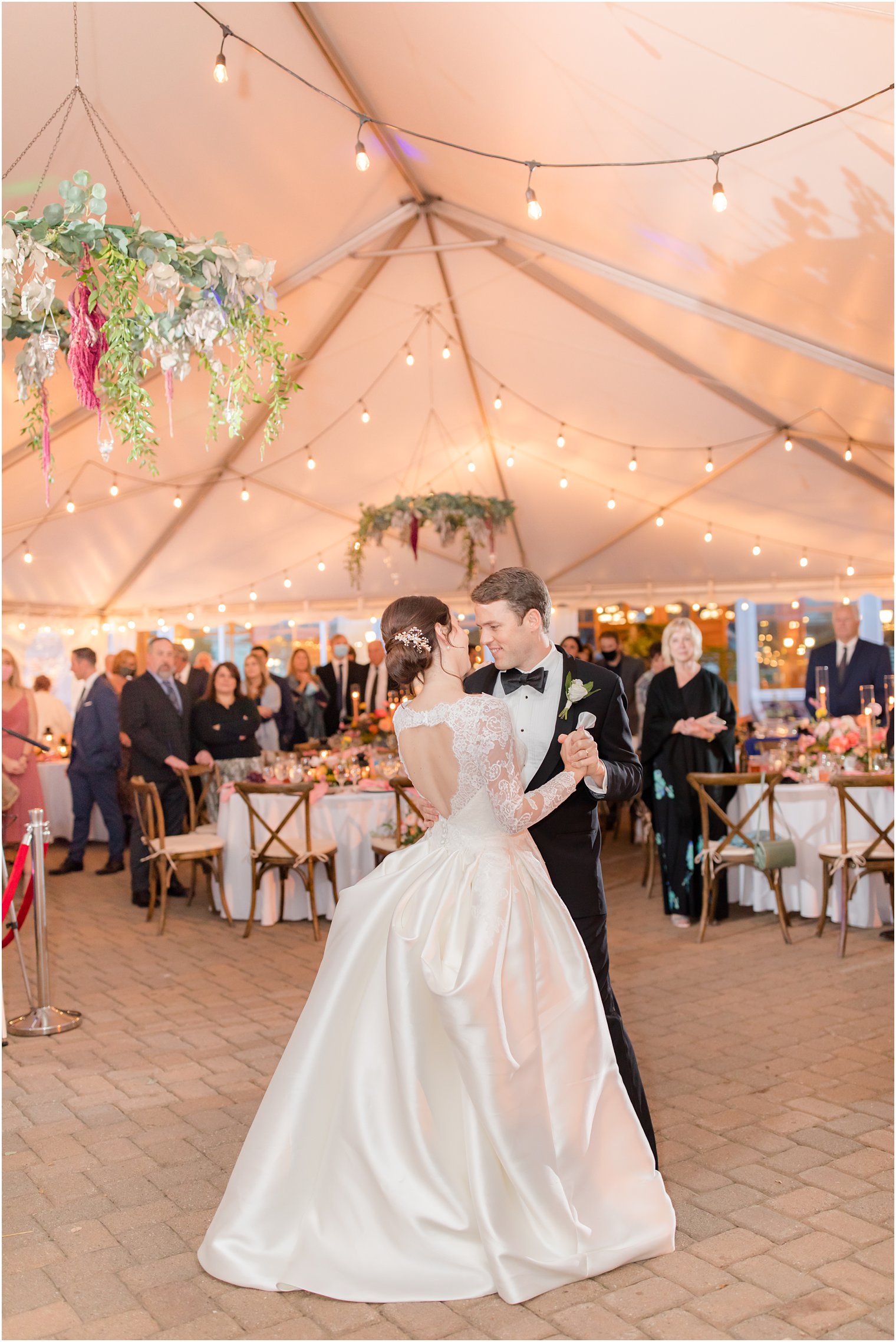 bride and groom dance during tented wedding reception