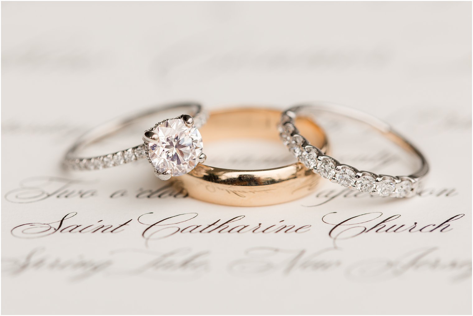 wedding rings rest on invitation for The Mill Lakeside Manor Wedding