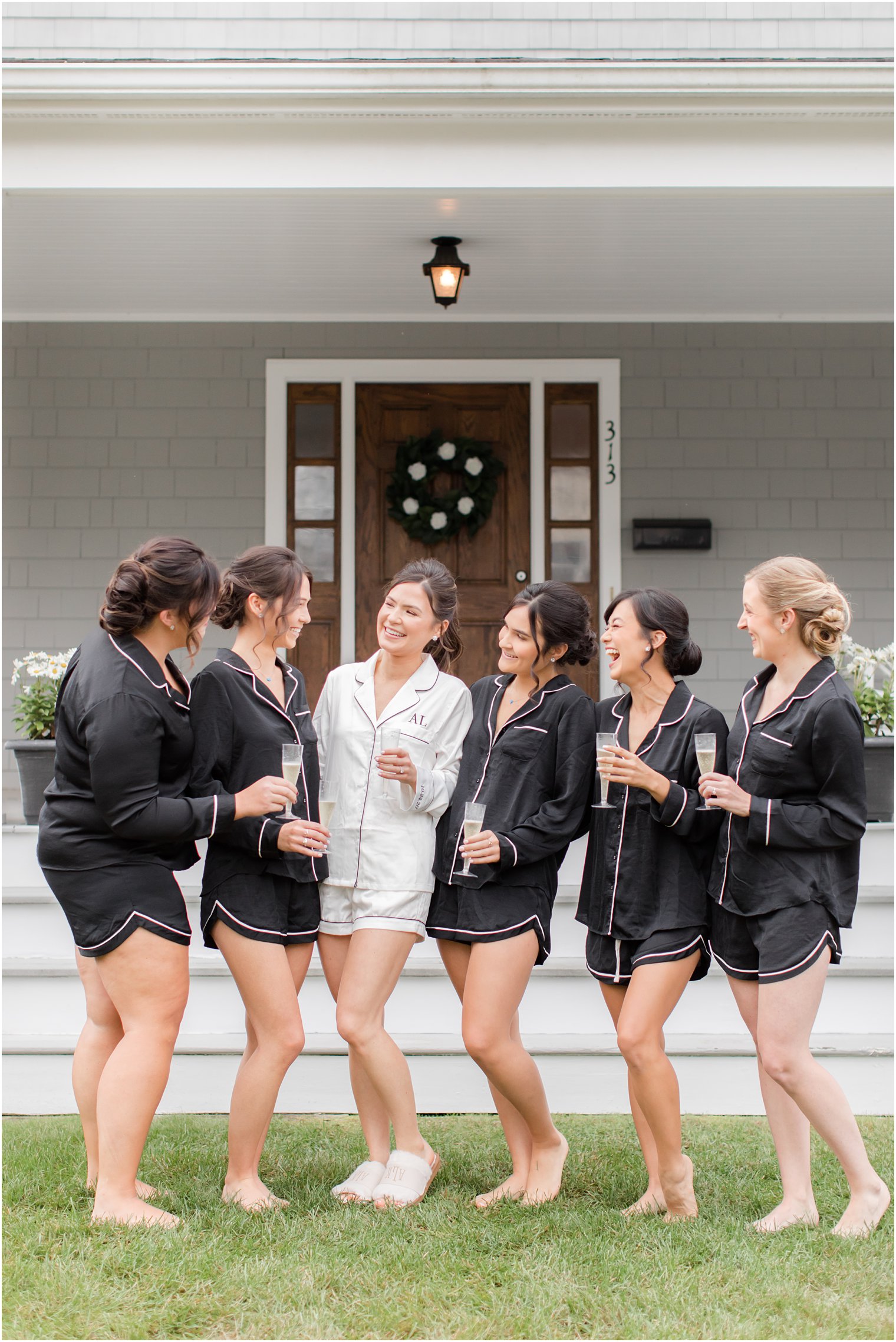 bride poses with bridesmaids in matching pjs