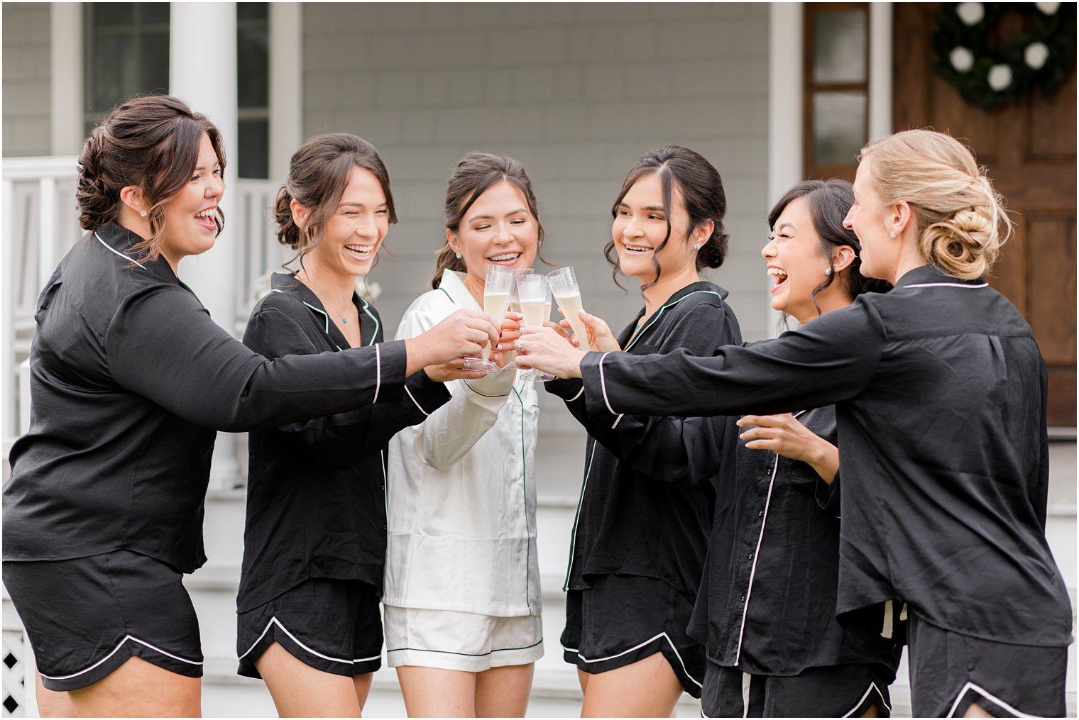 bride and bridesmaids toast with champagne