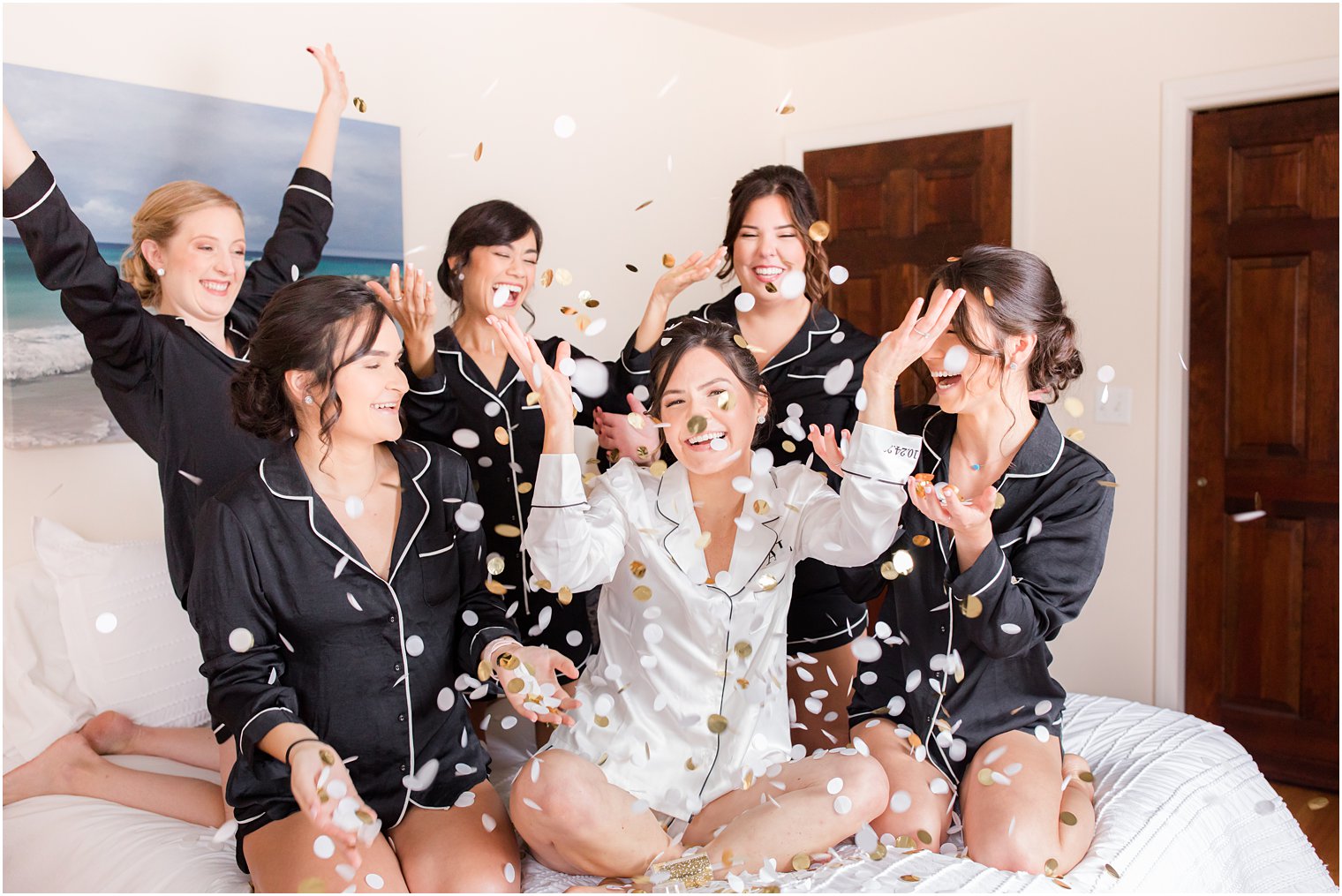 bride throws confetti with bridesmaids