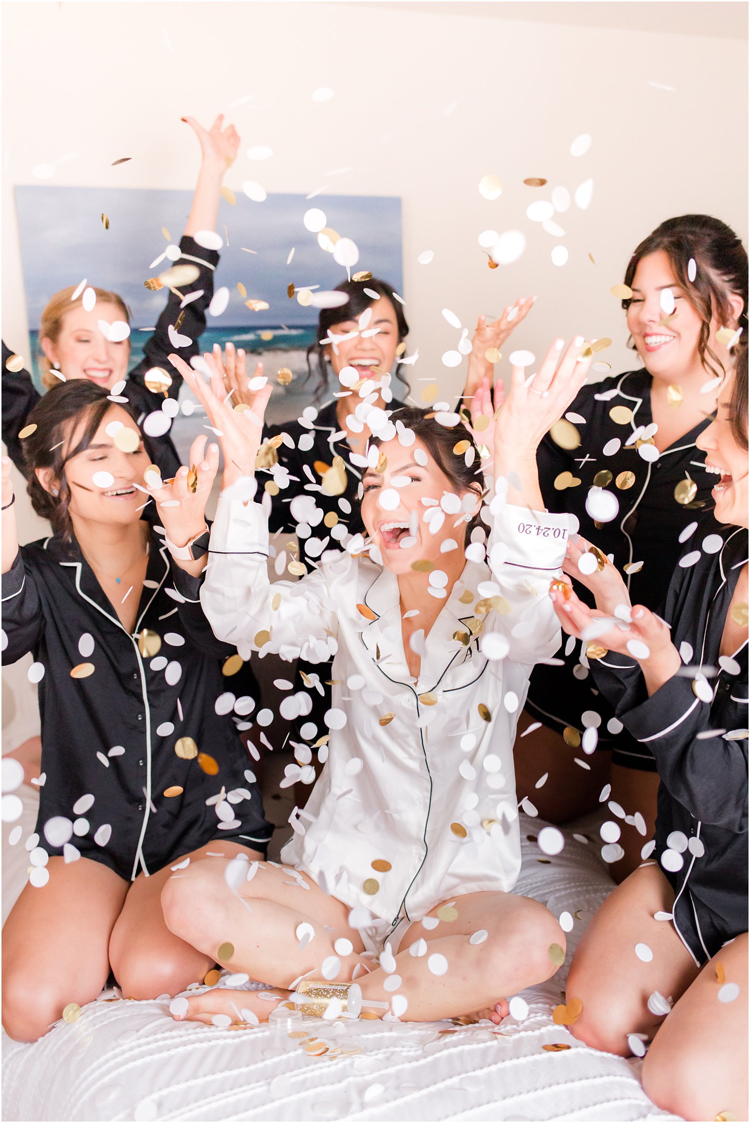 bride tosses confetti with bridesmaids