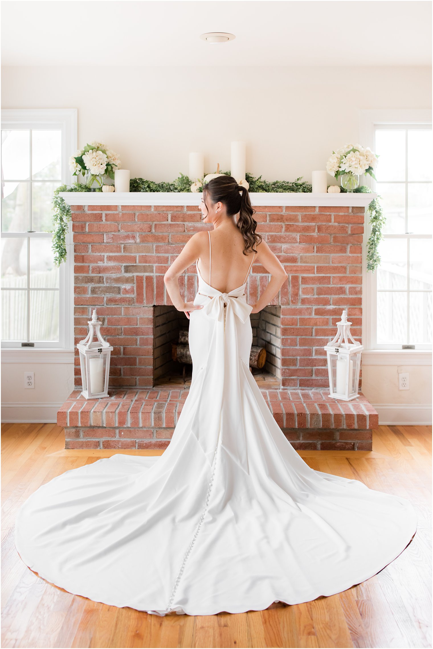 bride shows off modern wedding dress with bow on the back