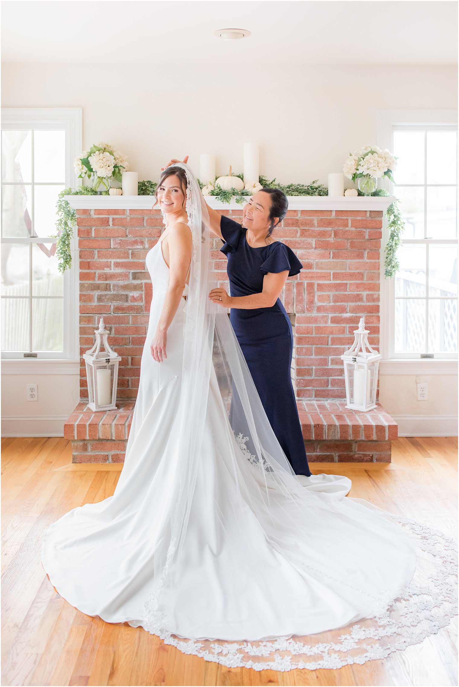 mom helps daughter adjust veil before The Mill Lakeside Manor wedding