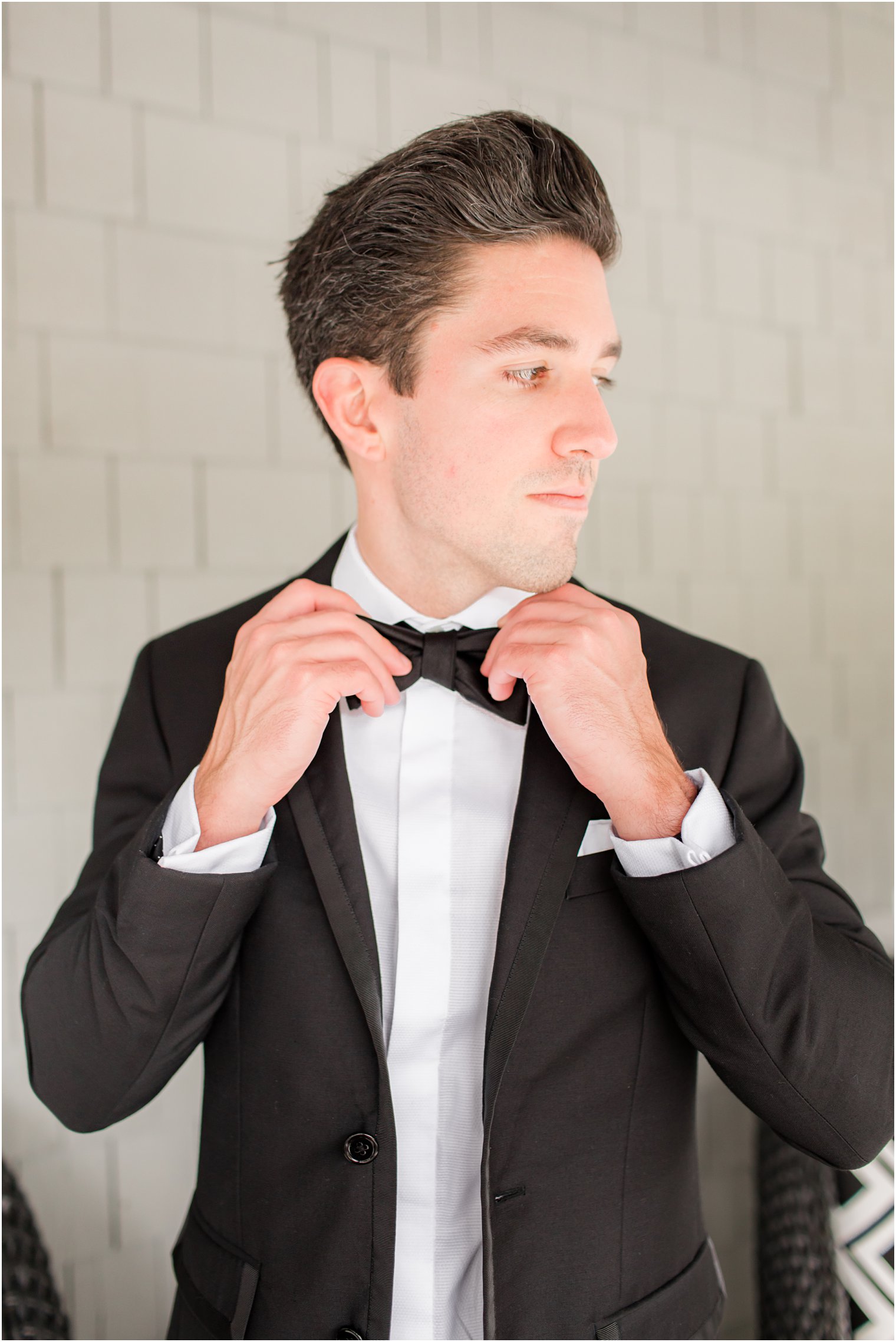 groom adjusts tie before The Mill Lakeside Manor wedding