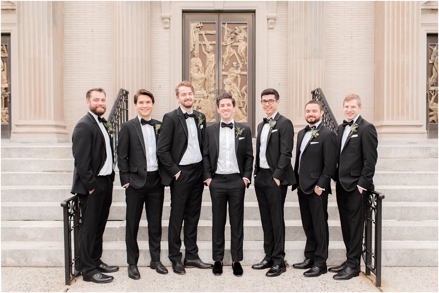 groom and groomsmen pose outside St. Catharine's Church