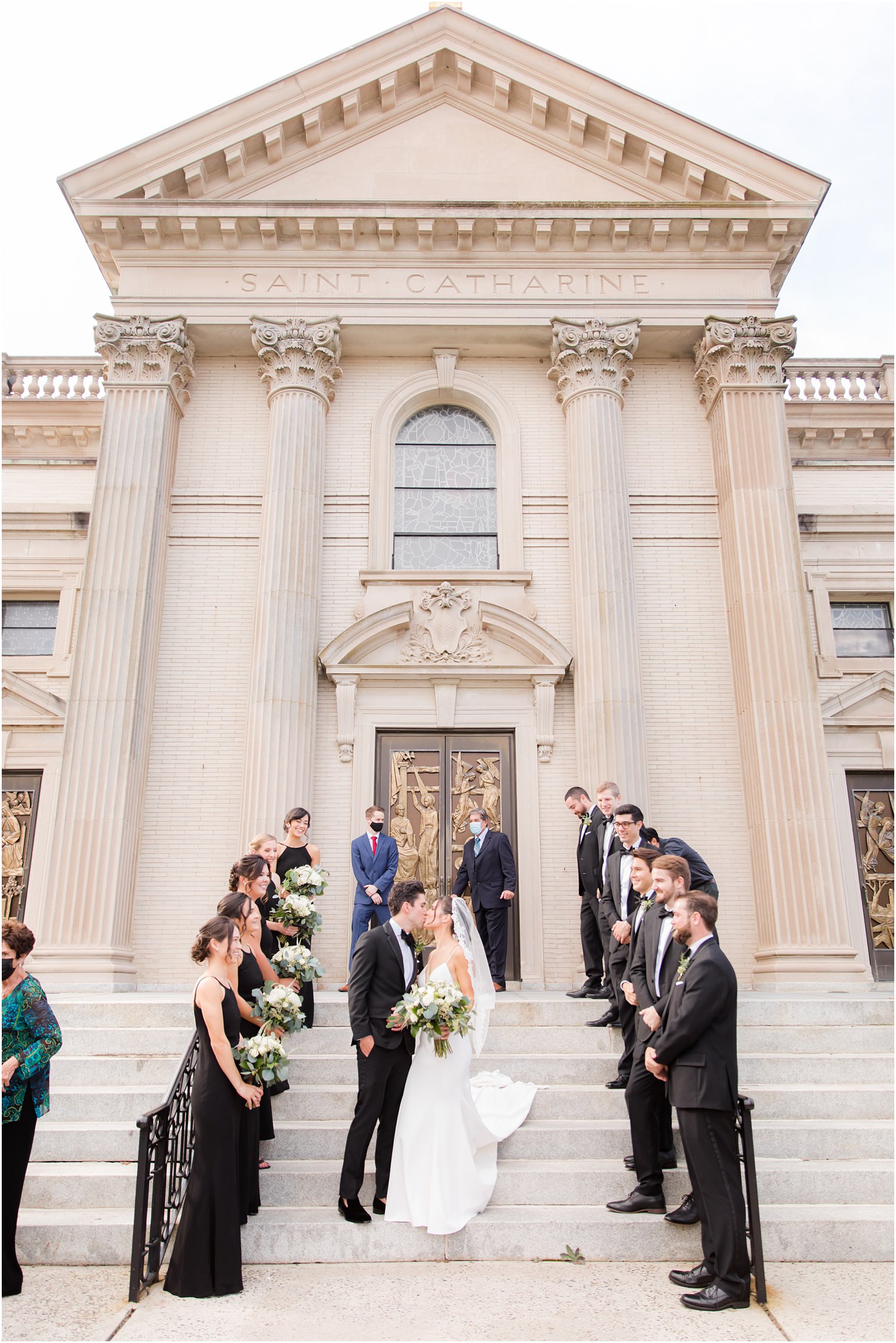 bride and groom kiss on steps of St. Catharine's Church in Spring Lake NJ