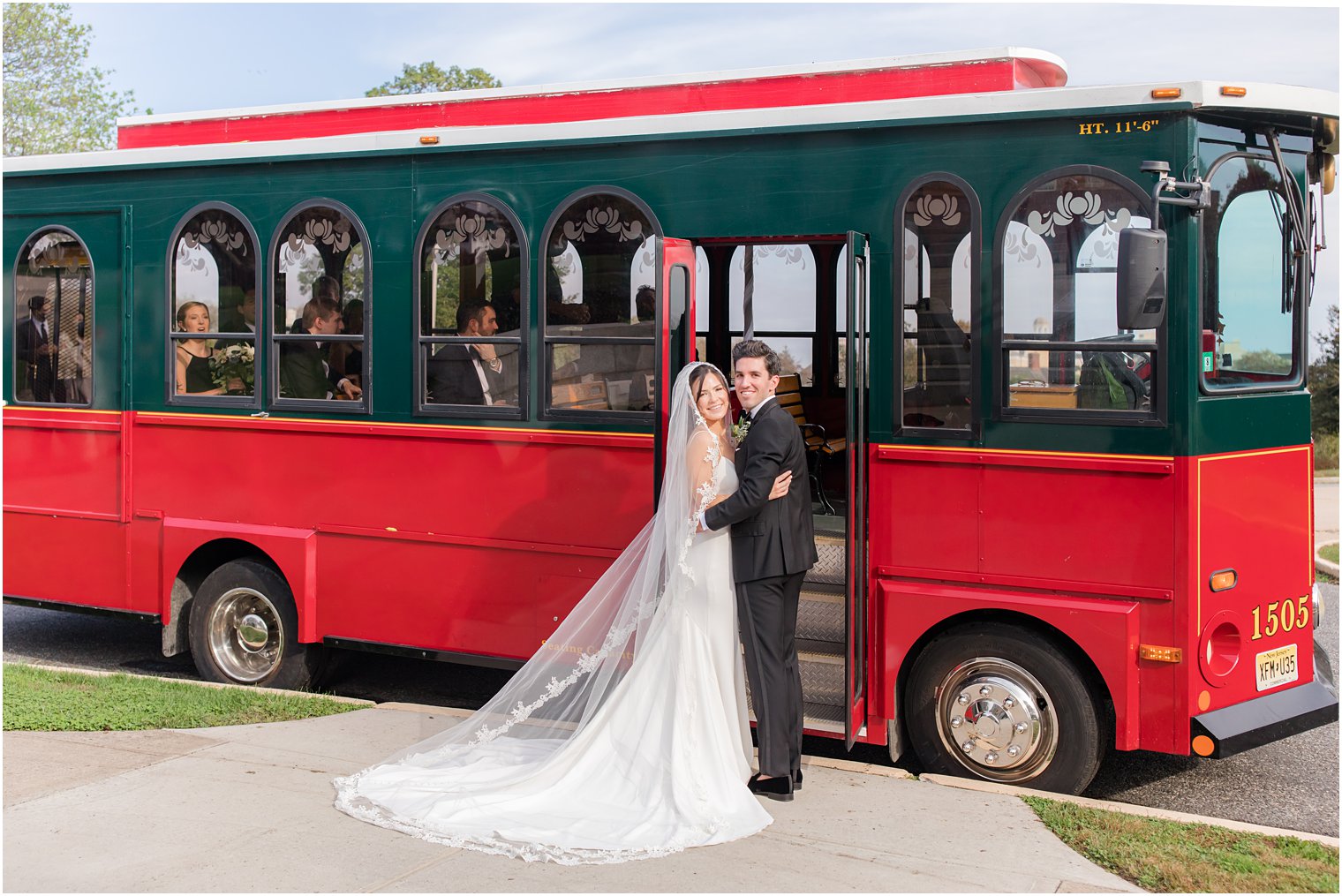 bride and groom pose by trolley in Spring Lake NJ