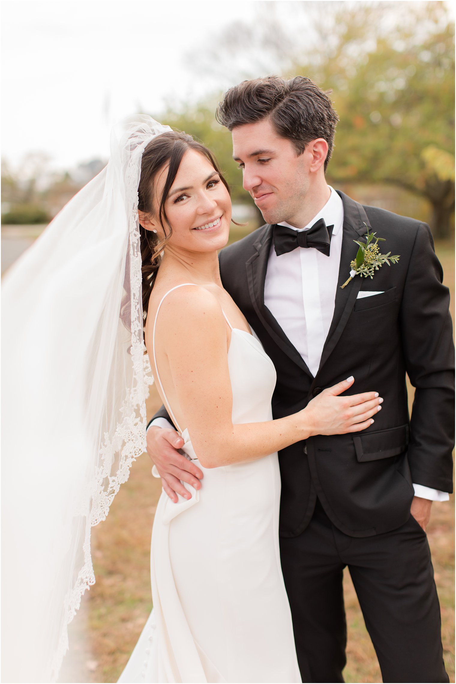 bride hugs groom during NJ wedding photos