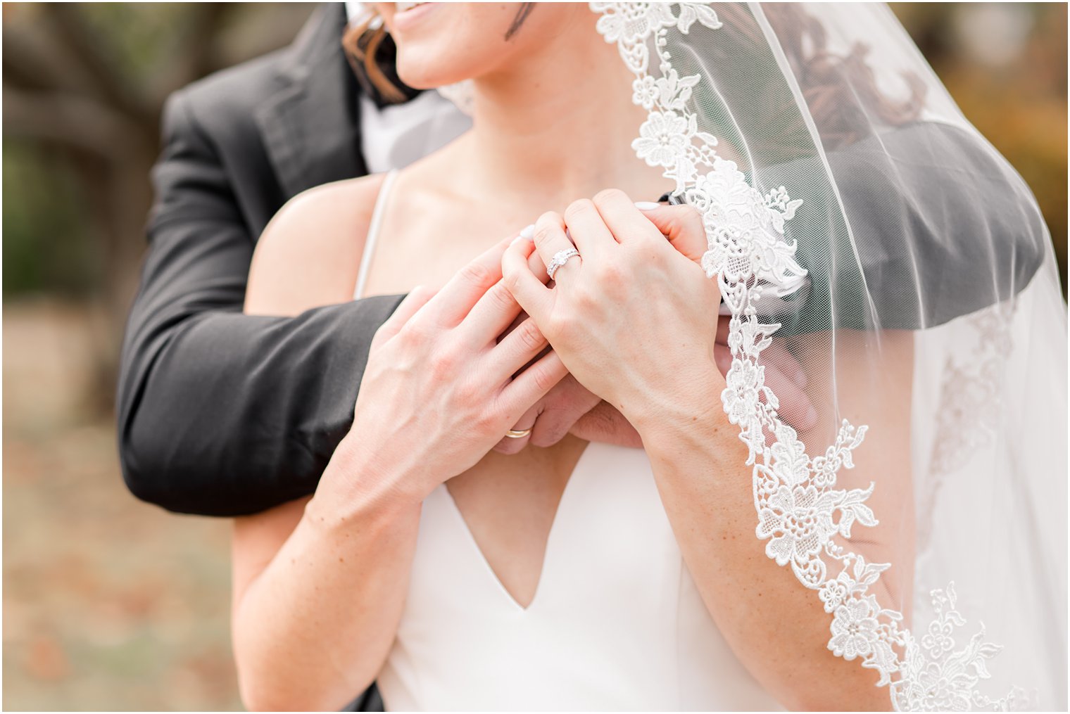 groom hugs bride and bride rests hands on his