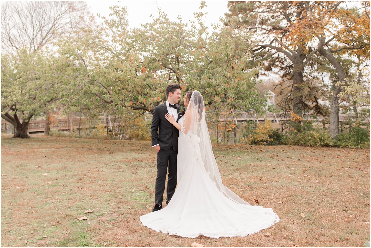 bride and groom look at each other during photos in Divine Park in Spring Lake NJ