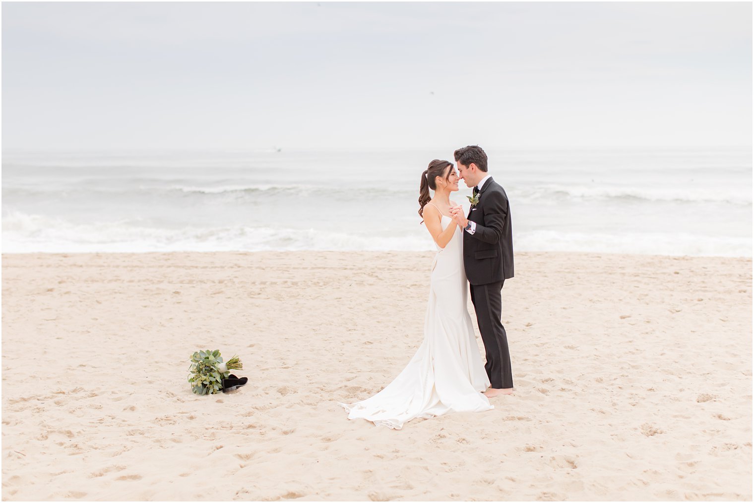 bride and groom dance on Spring Lake Beach