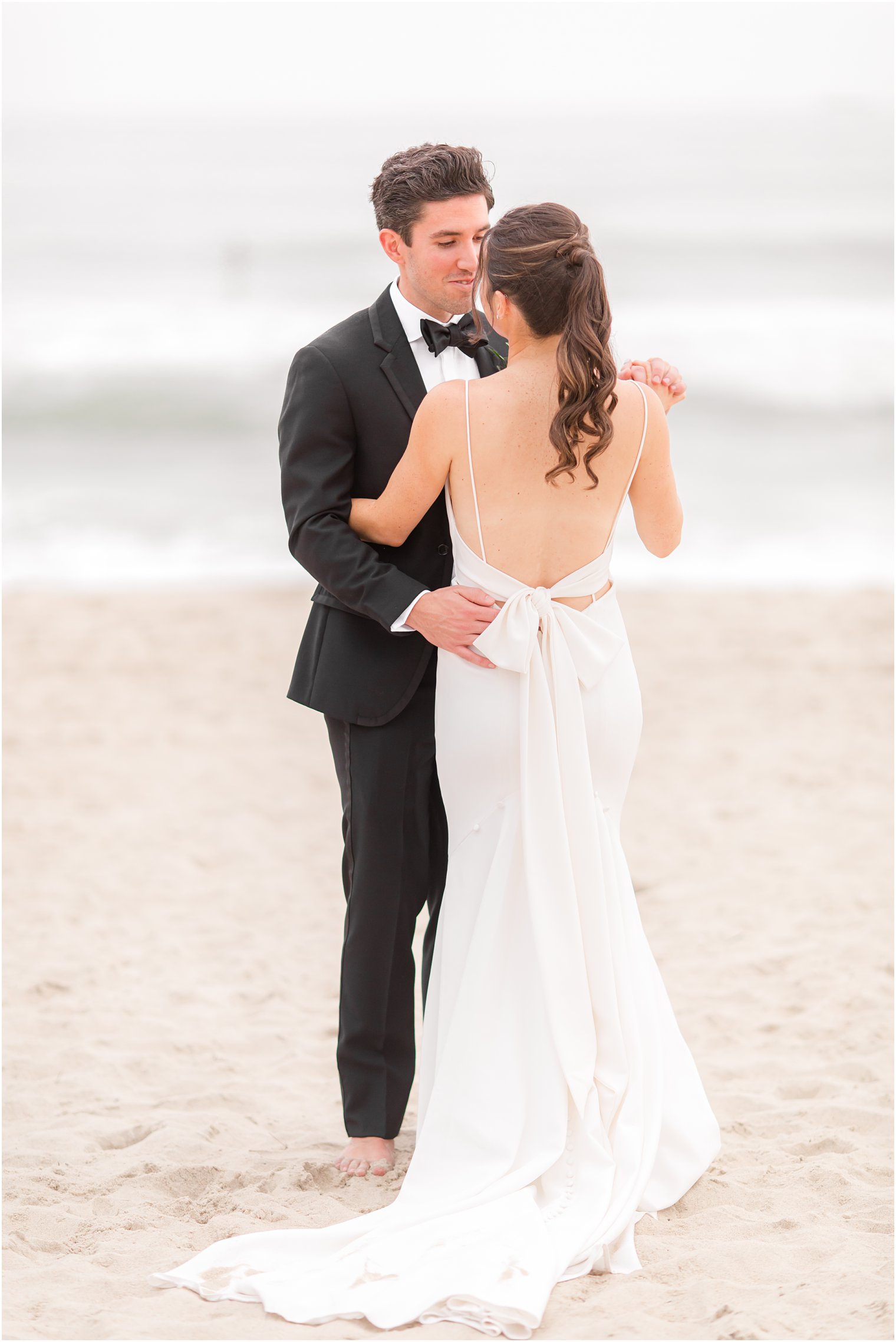 Spring Lake Beach wedding portraits of bride and groom dancing