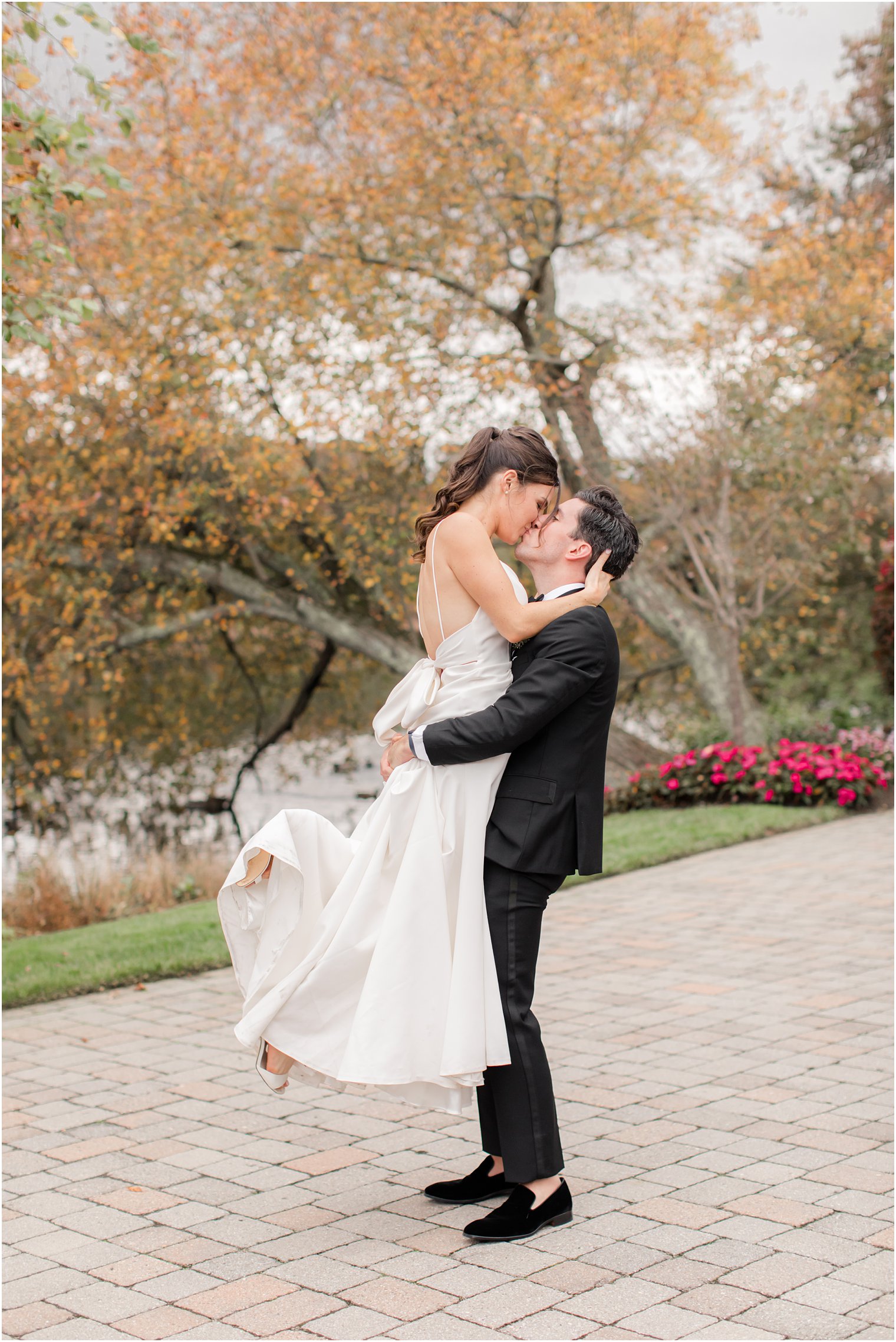 groom lifts bride during NJ wedding photos