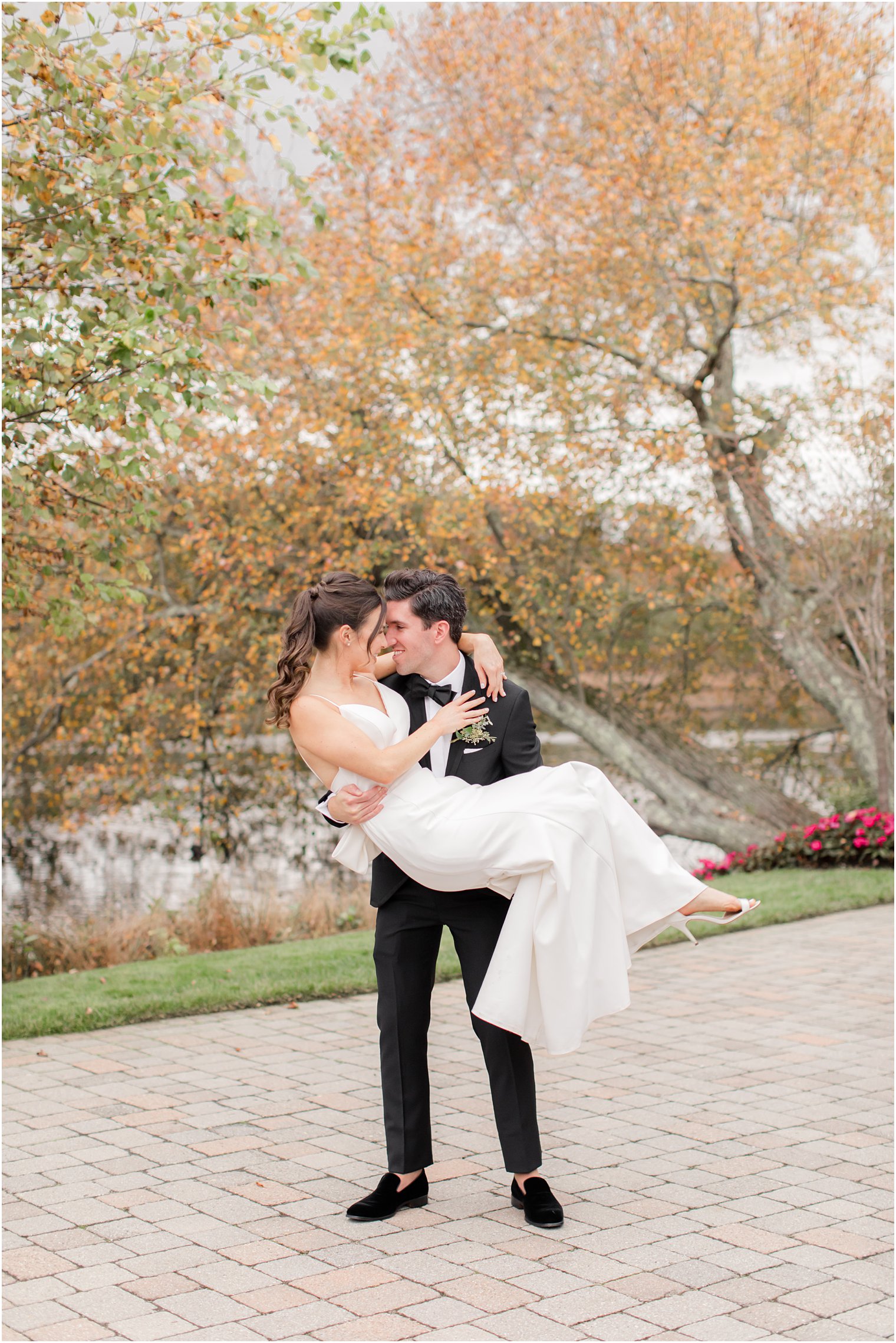 groom picks up bride during The Mill Lakeside Manor wedding photos