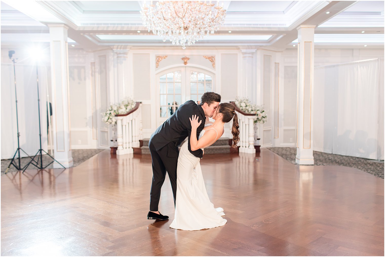 groom kisses bride and dips her during The Mill Lakeside Manor wedding reception