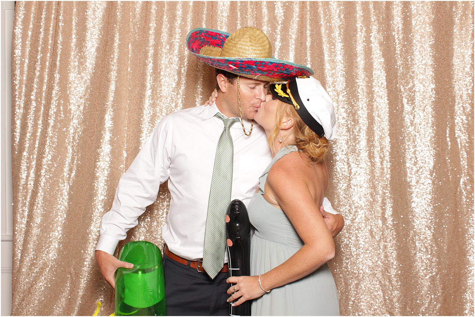 wedding guests kiss in photo booth