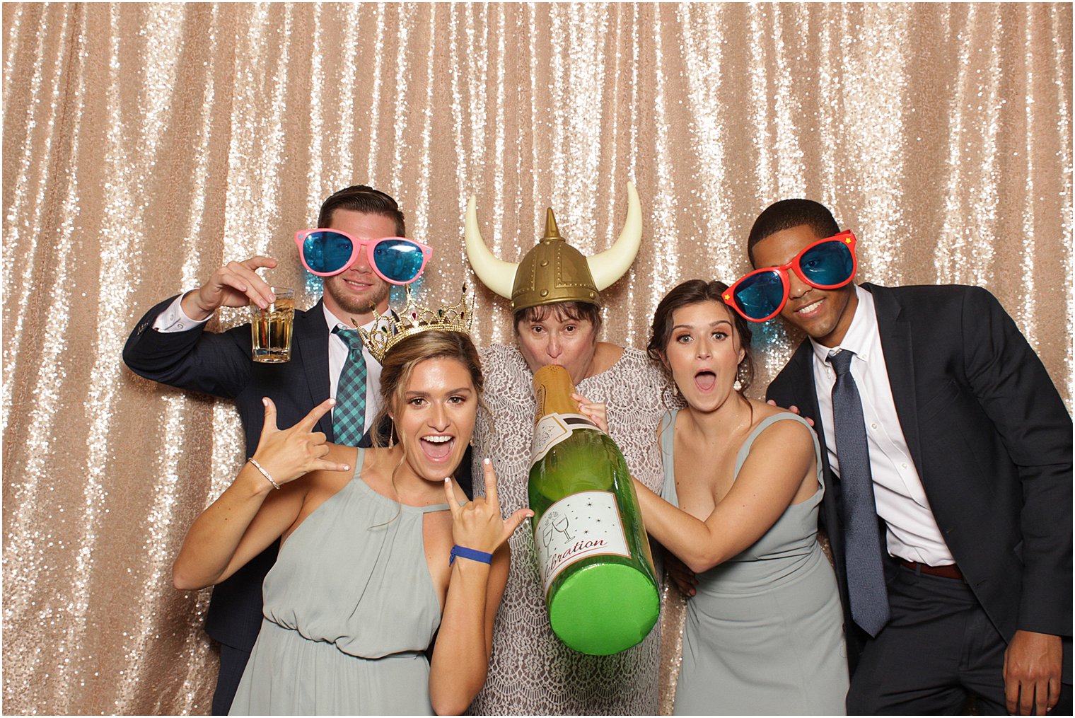 bridesmaids hold blow up champagne bottle during NJ wedding reception