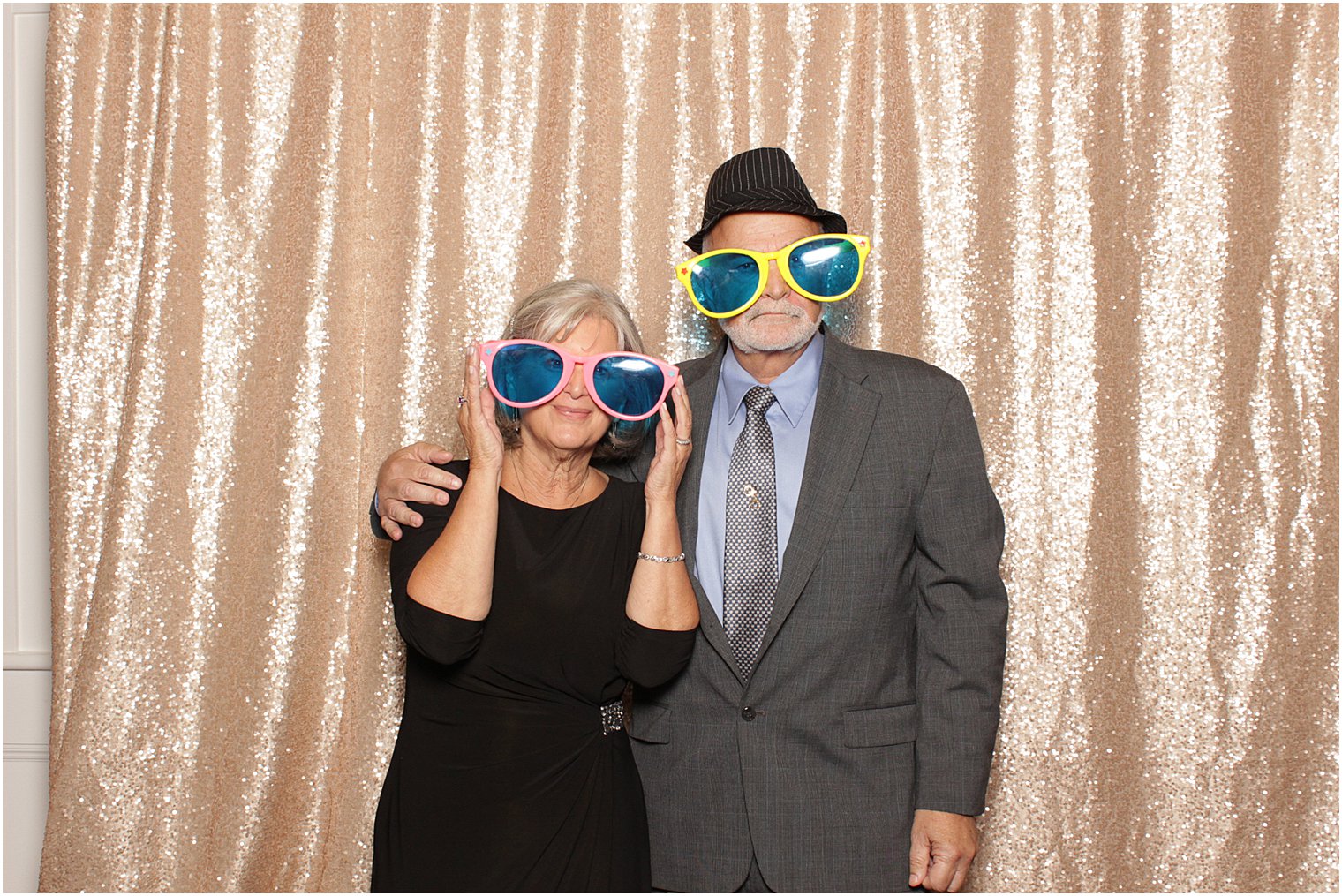 wedding guests wearing sunglasses pose in Bridgeview Yacht Club photo booth