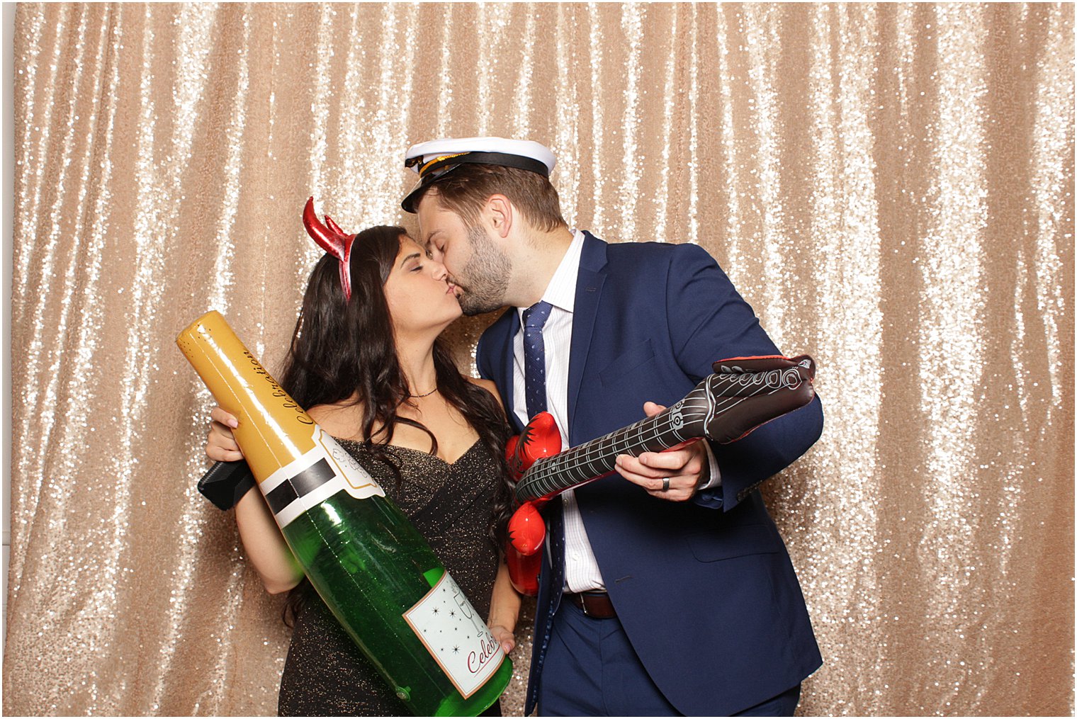 wedding guests kiss during Bridgeview Yacht Club photo booth