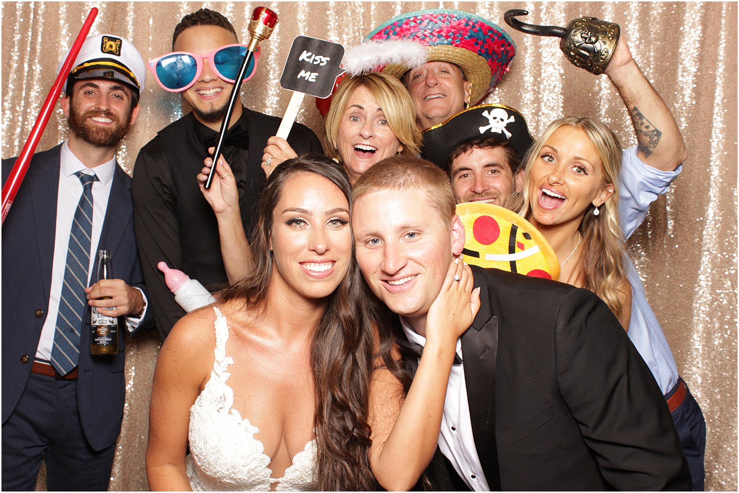 bride and groom pose with guests in photobooth at Bridgeview Yacht Club