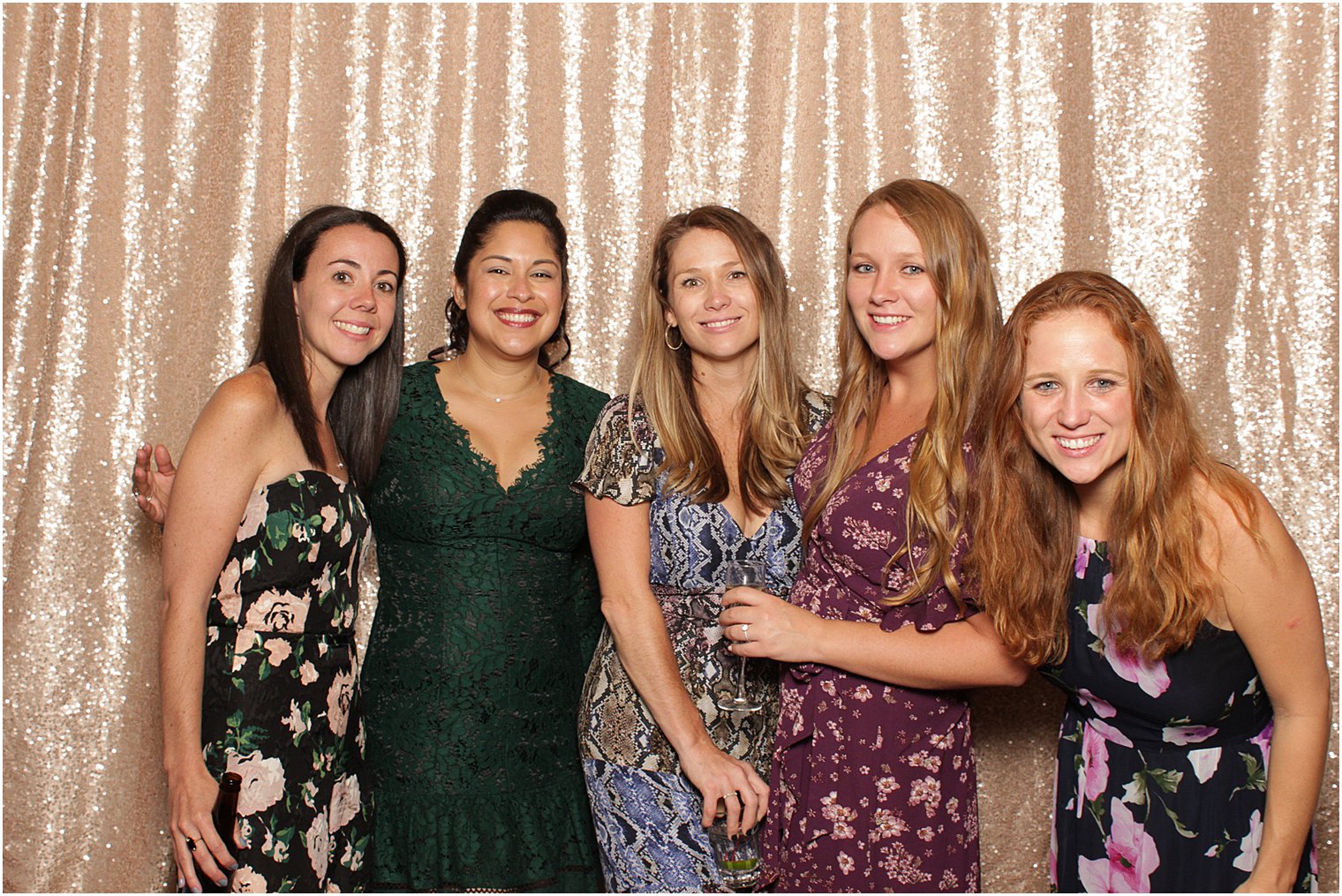 5 wedding guests stand in front of gold curtain