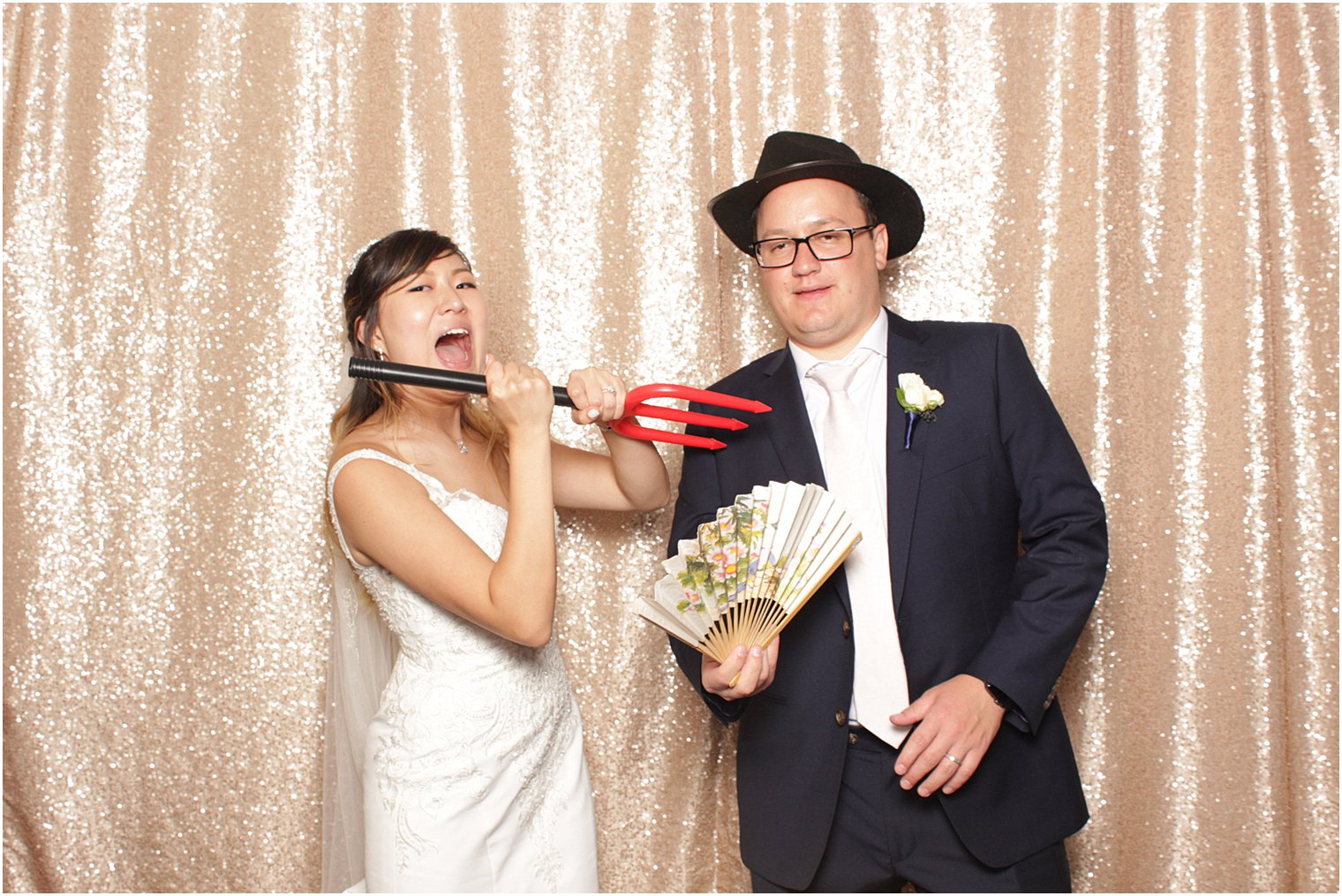 bride and groom pose in photo booth