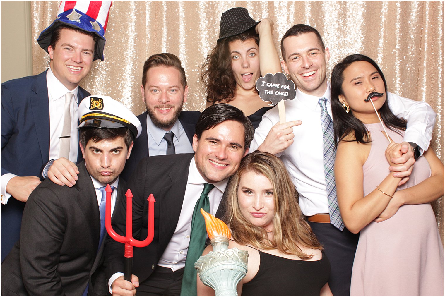group poses in photo booth during NJ wedding reception