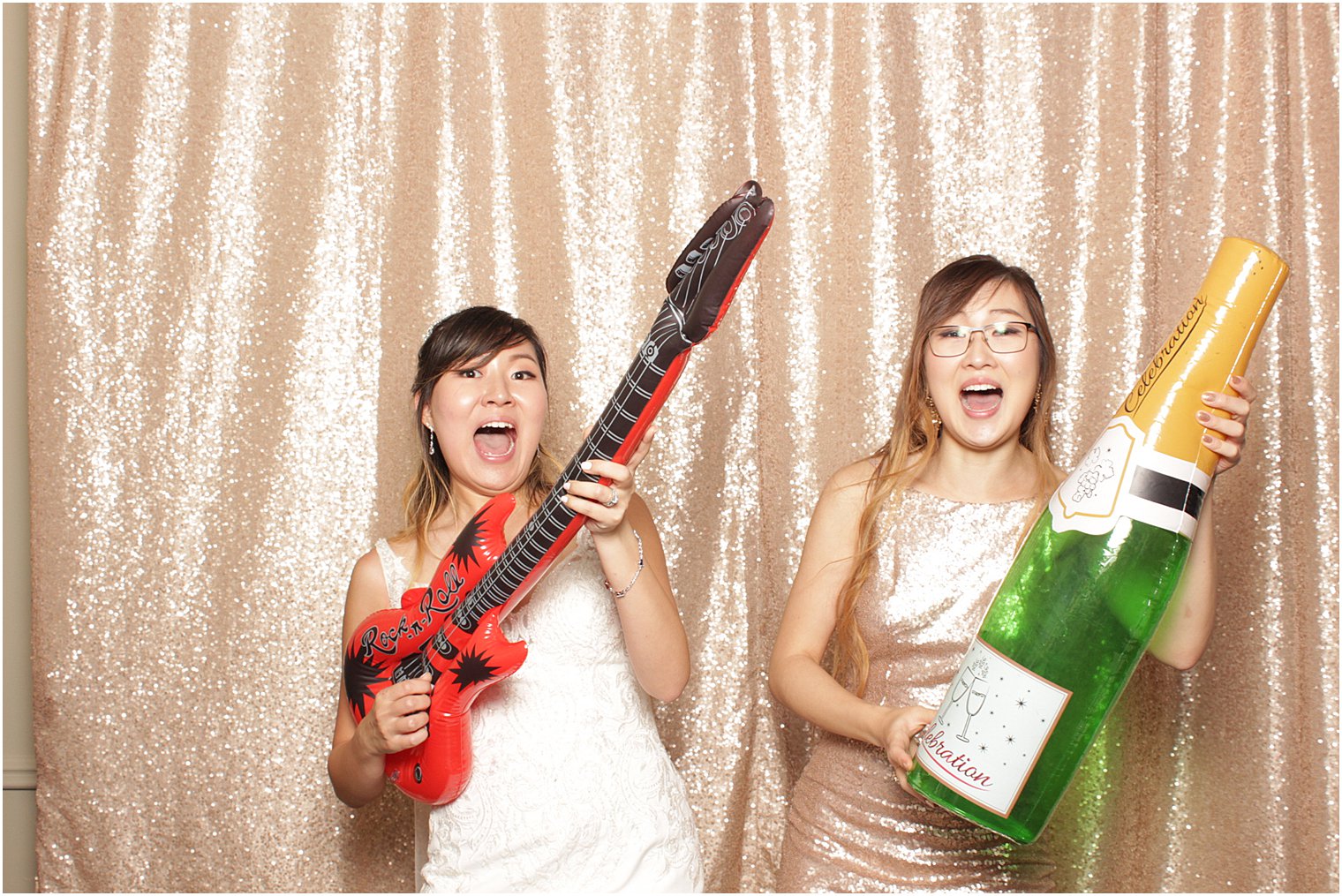 bride dances with sister in photo booth