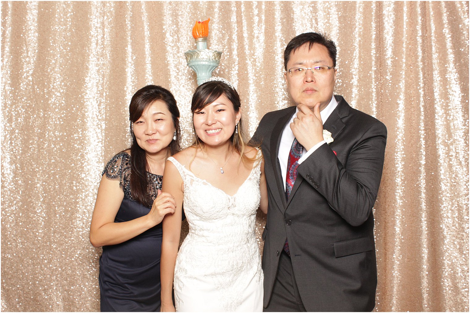 bride poses with parents during NJ wedding reception