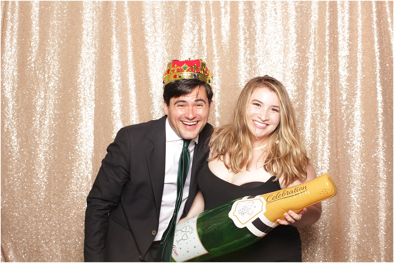 wedding guests pose with inflatable champagne glass during photo booth fun