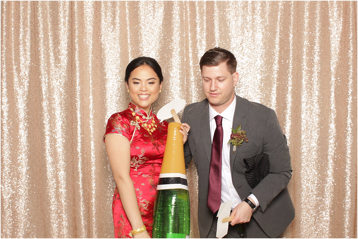 bride and groom pose in photo booth during NJ wedding reception