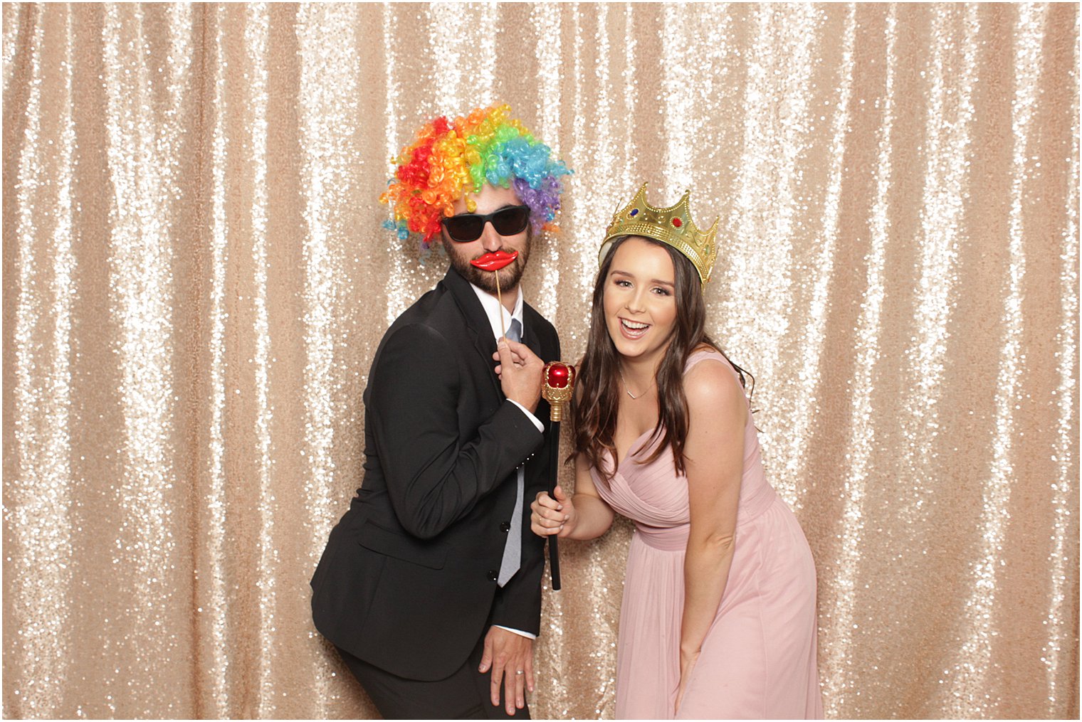 bridesmaid wears crown with guest in colorful wig