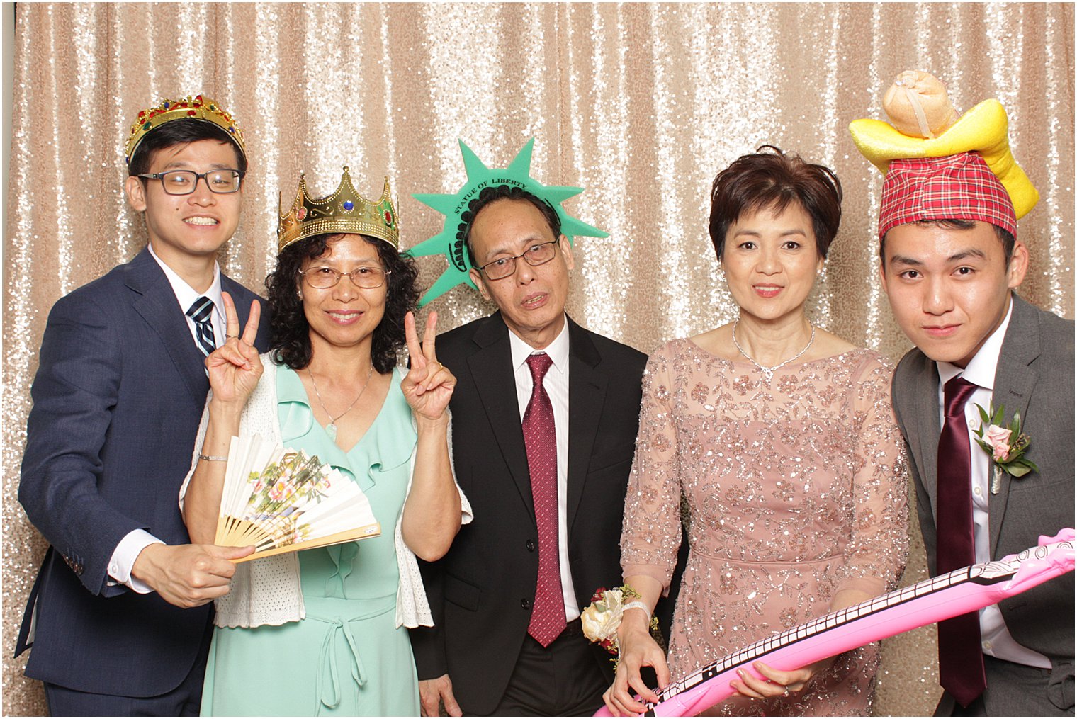 wedding guests wearing Statue of Liberty hats play in Park Chateau Estate Photo Booth