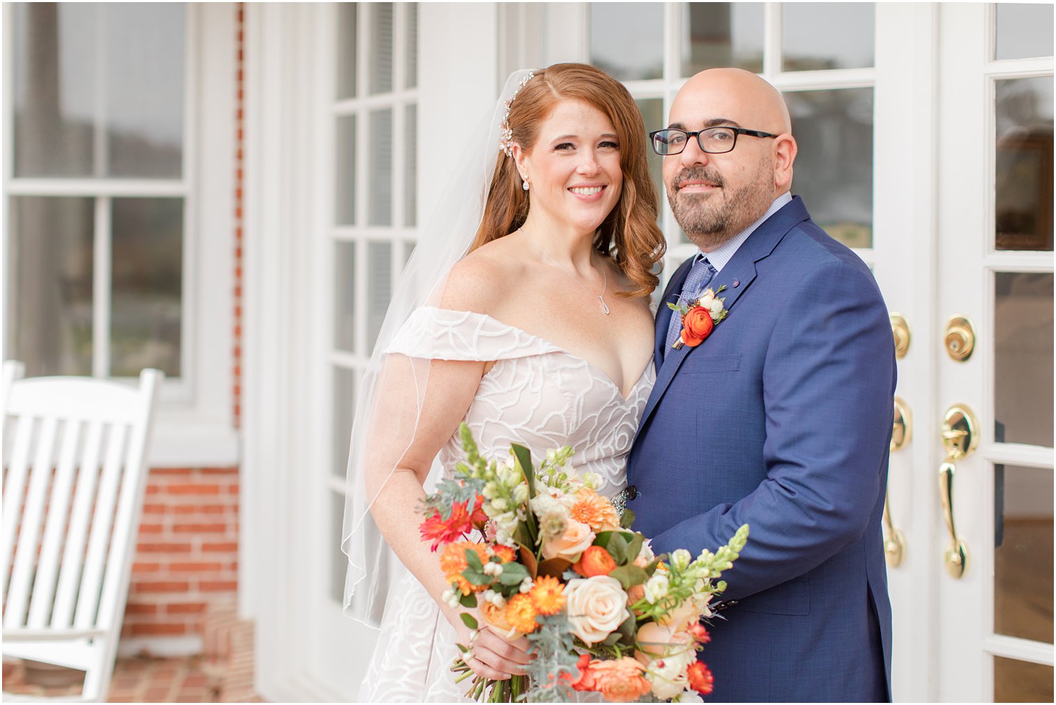 bride and groom pose outside Eagle Manor