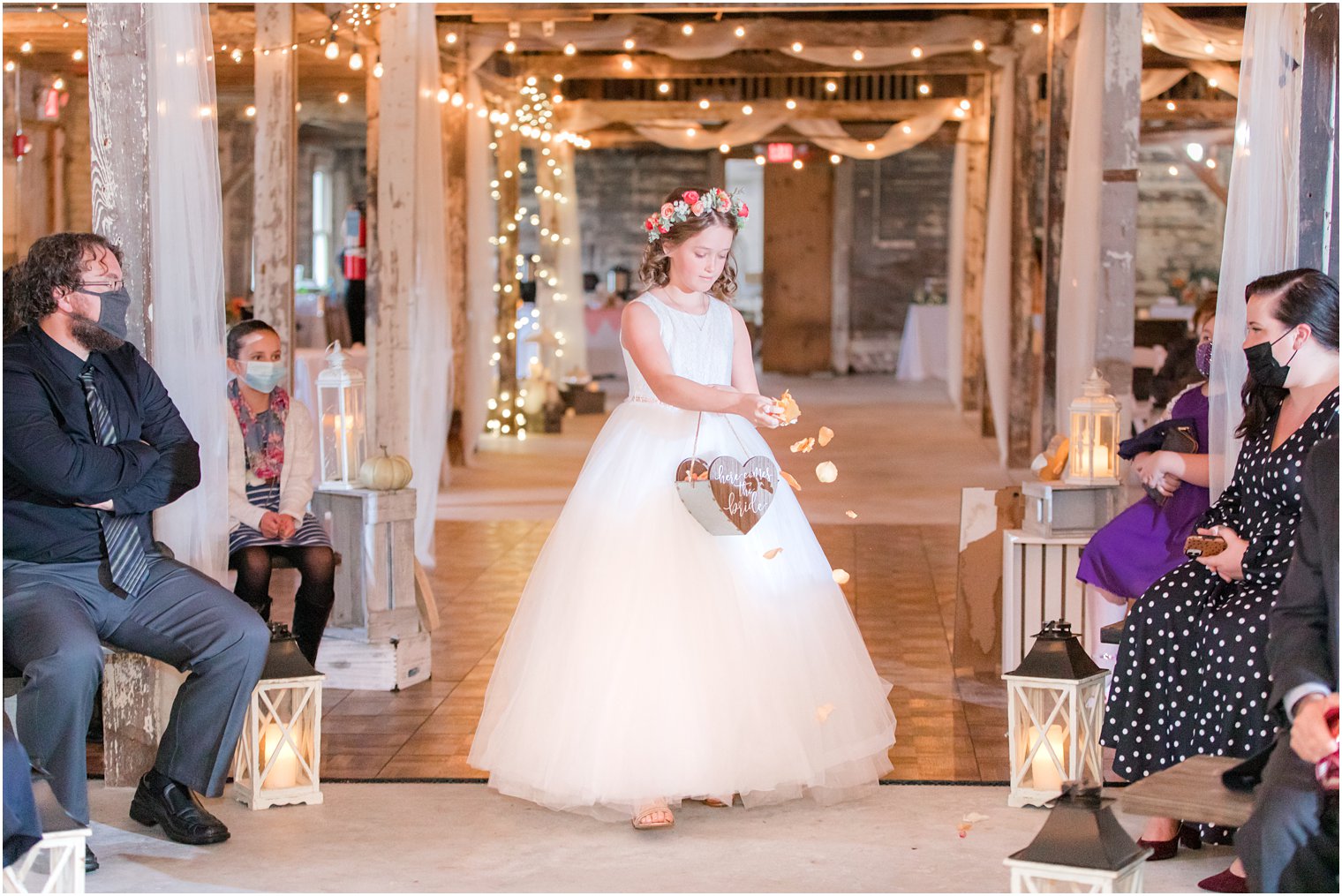 bride's daughter walks down the aisle with flower petals