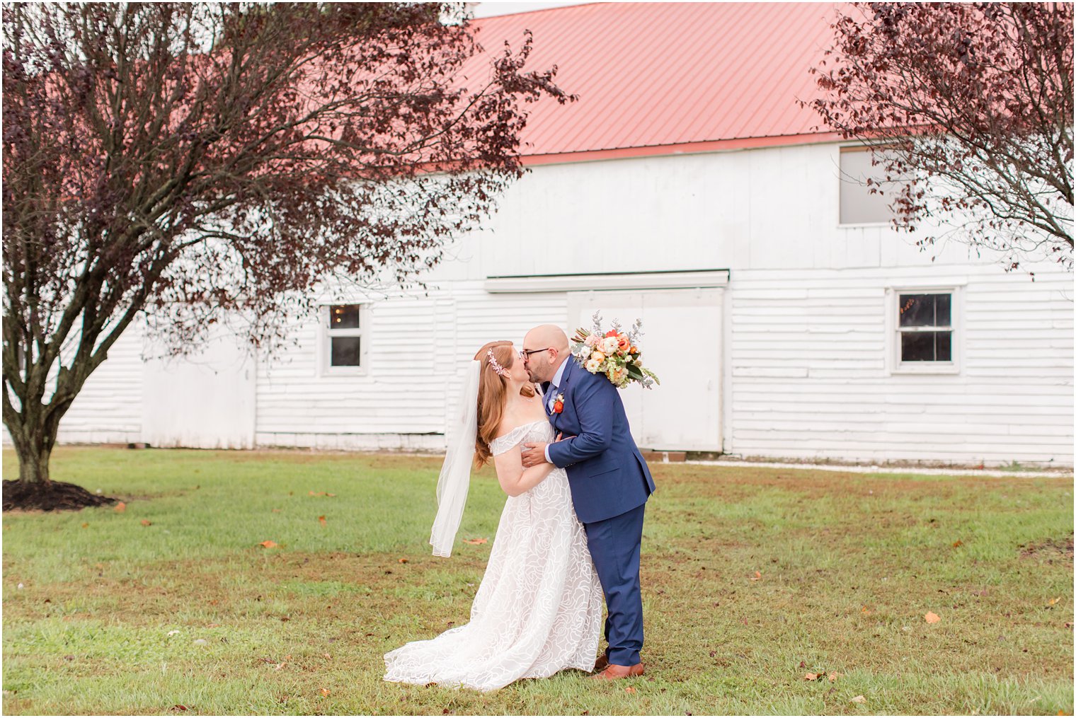 newlyweds kiss outside Eagle Manor on wedding day