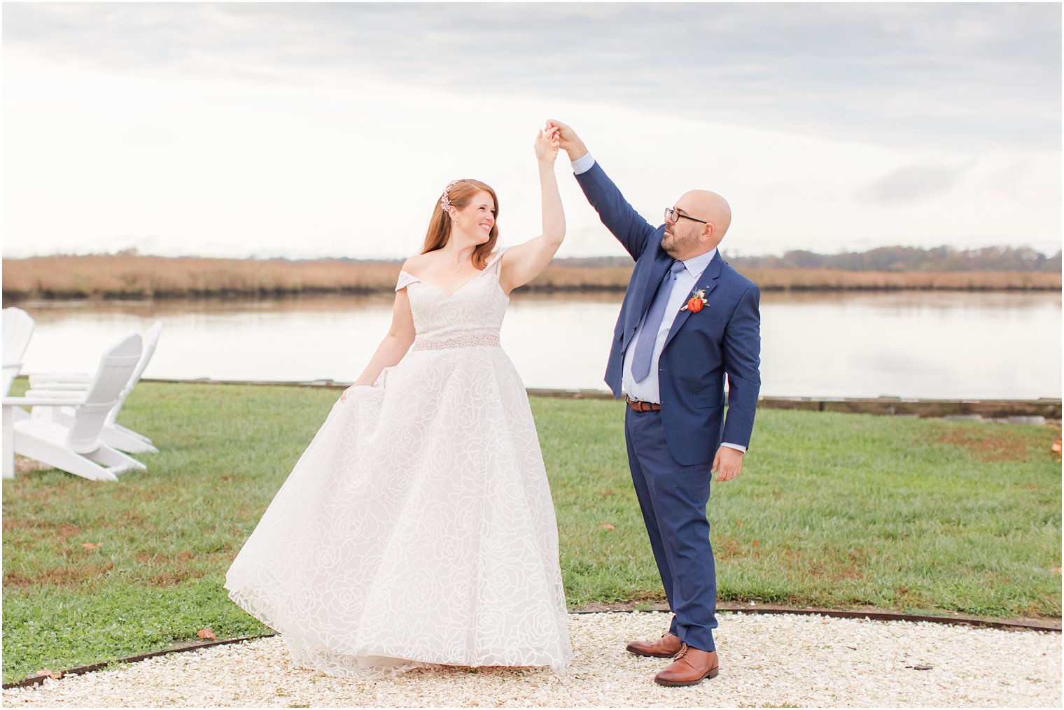 waterfront wedding portraits of bride and groom dancing