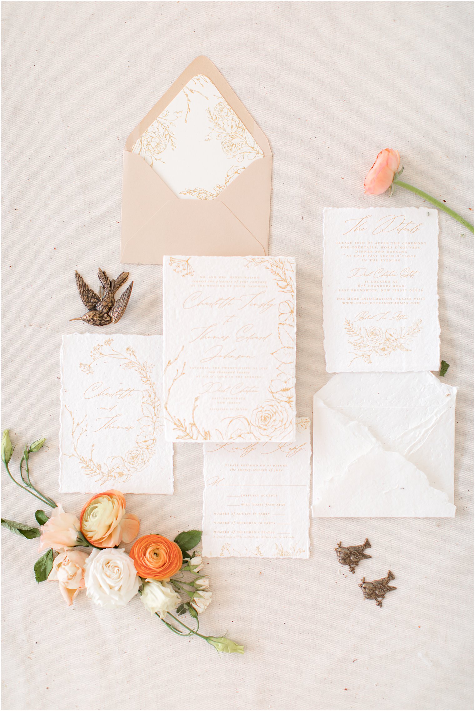Stationery flat lay of neutral colored invitation 