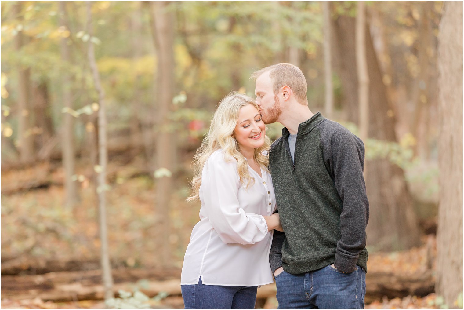 groom kisses bride's head during Ramapo Reservation engagement portraits