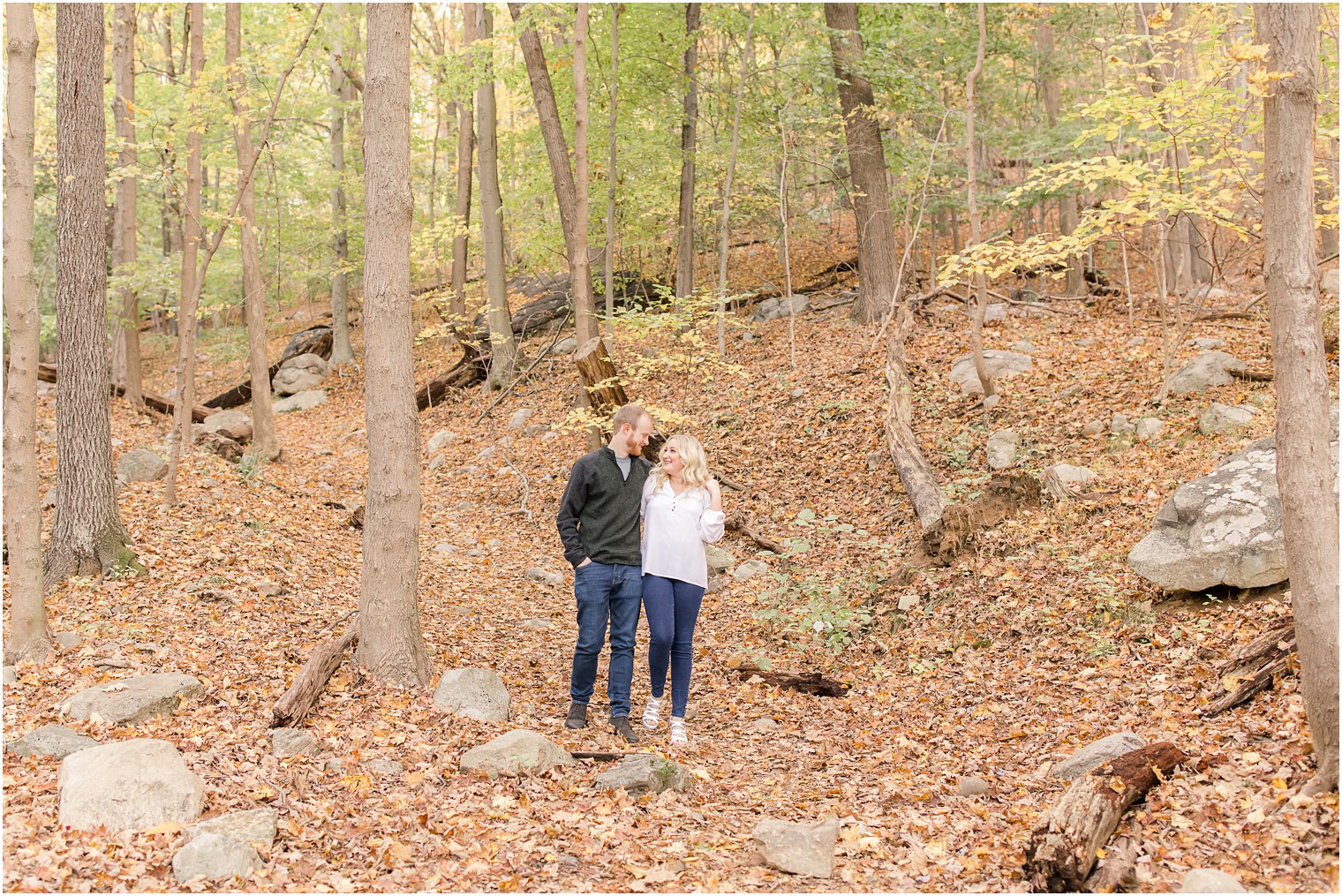 bride and groom walk through woods of Ramapo Reservation