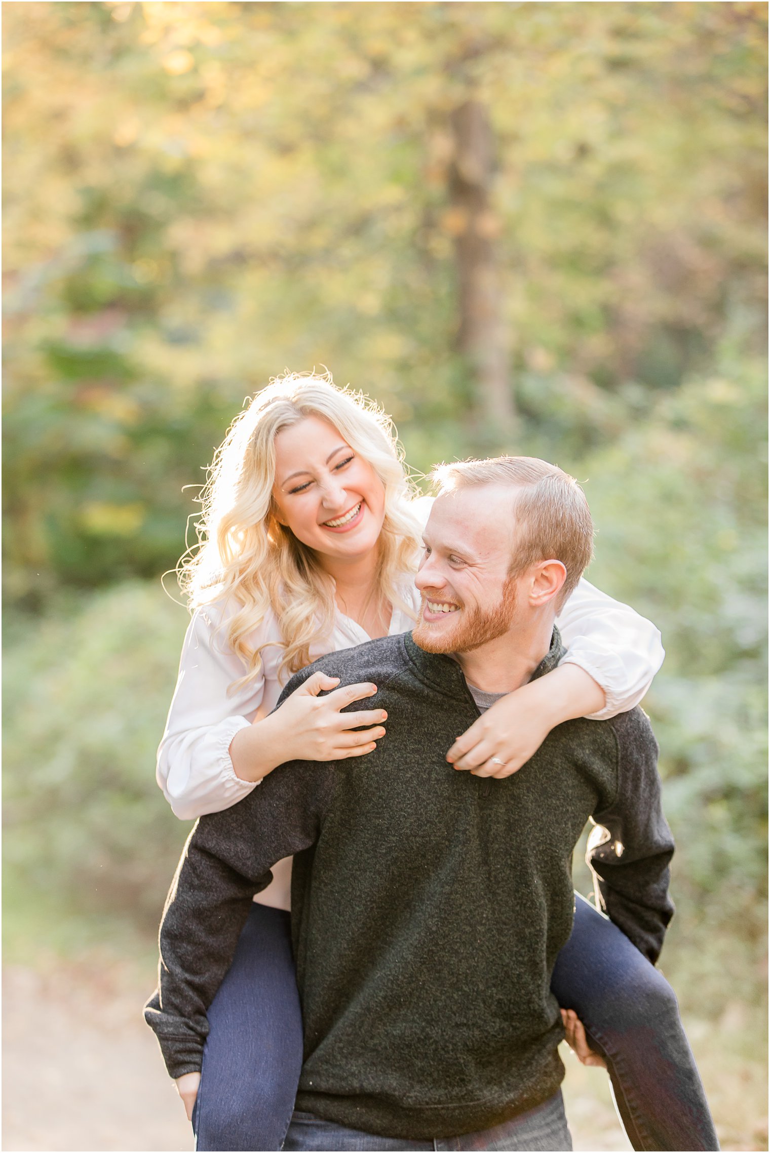 groom gives bride a piggy back ride during Ramapo Reservation