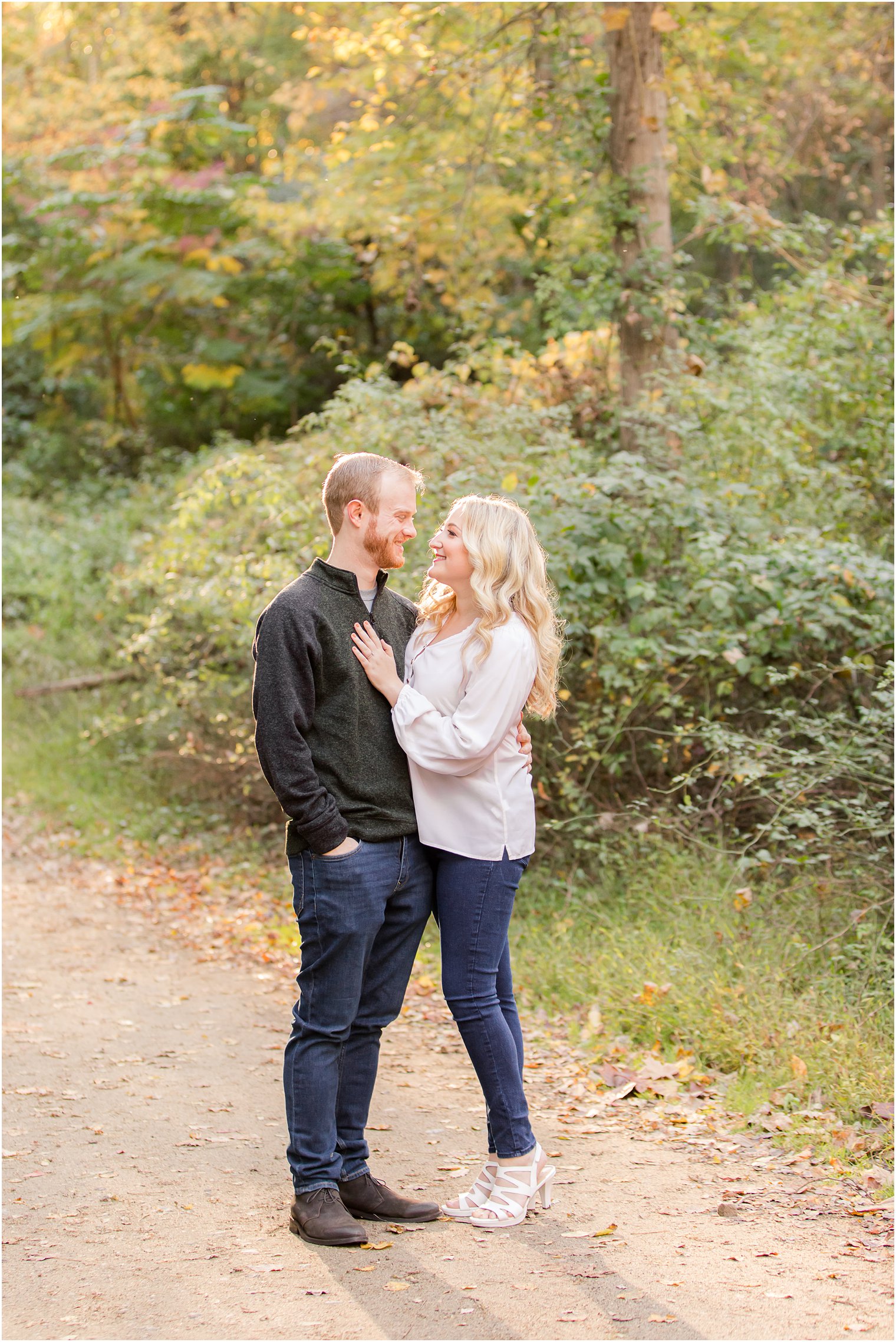 couple stands together on path in Ramapo Reservation