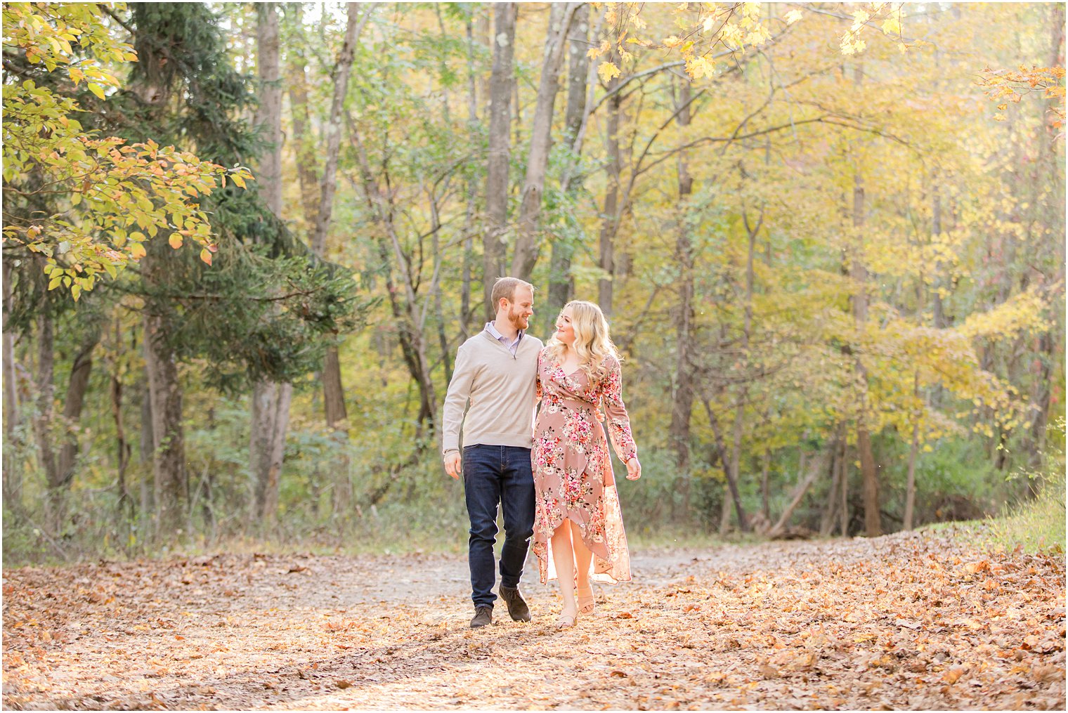 bride and groom walk along path in Ramapo Reservation