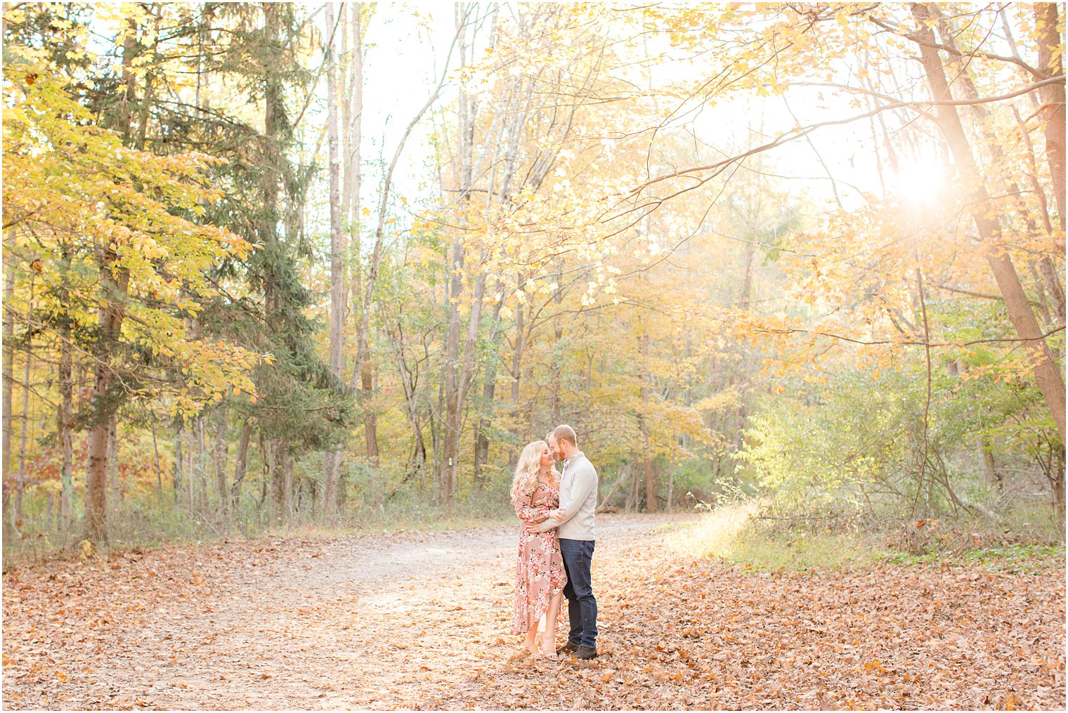 bride and groom cuddle on path during Ramapo Reservation engagement session