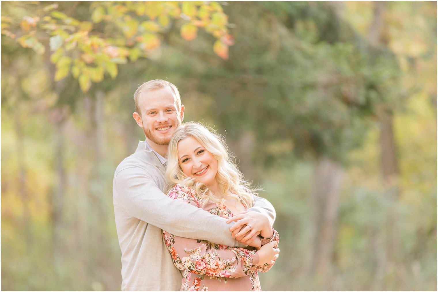 groom holds bride from behind during Ramapo Reservation engagement session