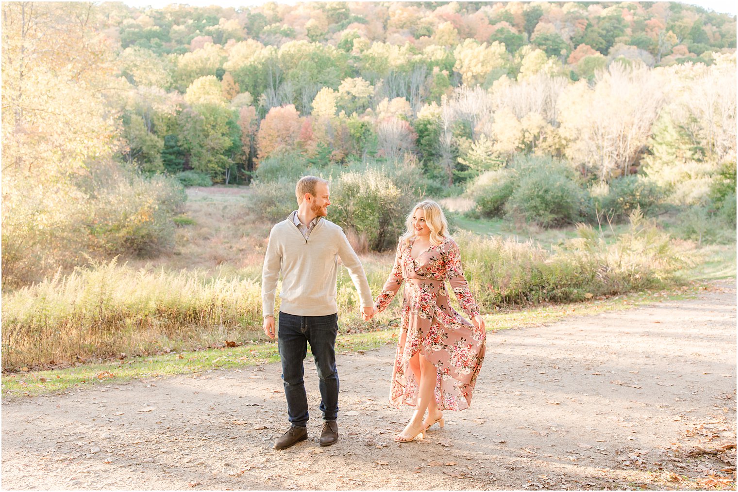 couple walks on pathway during fall Ramapo Reservation portraits