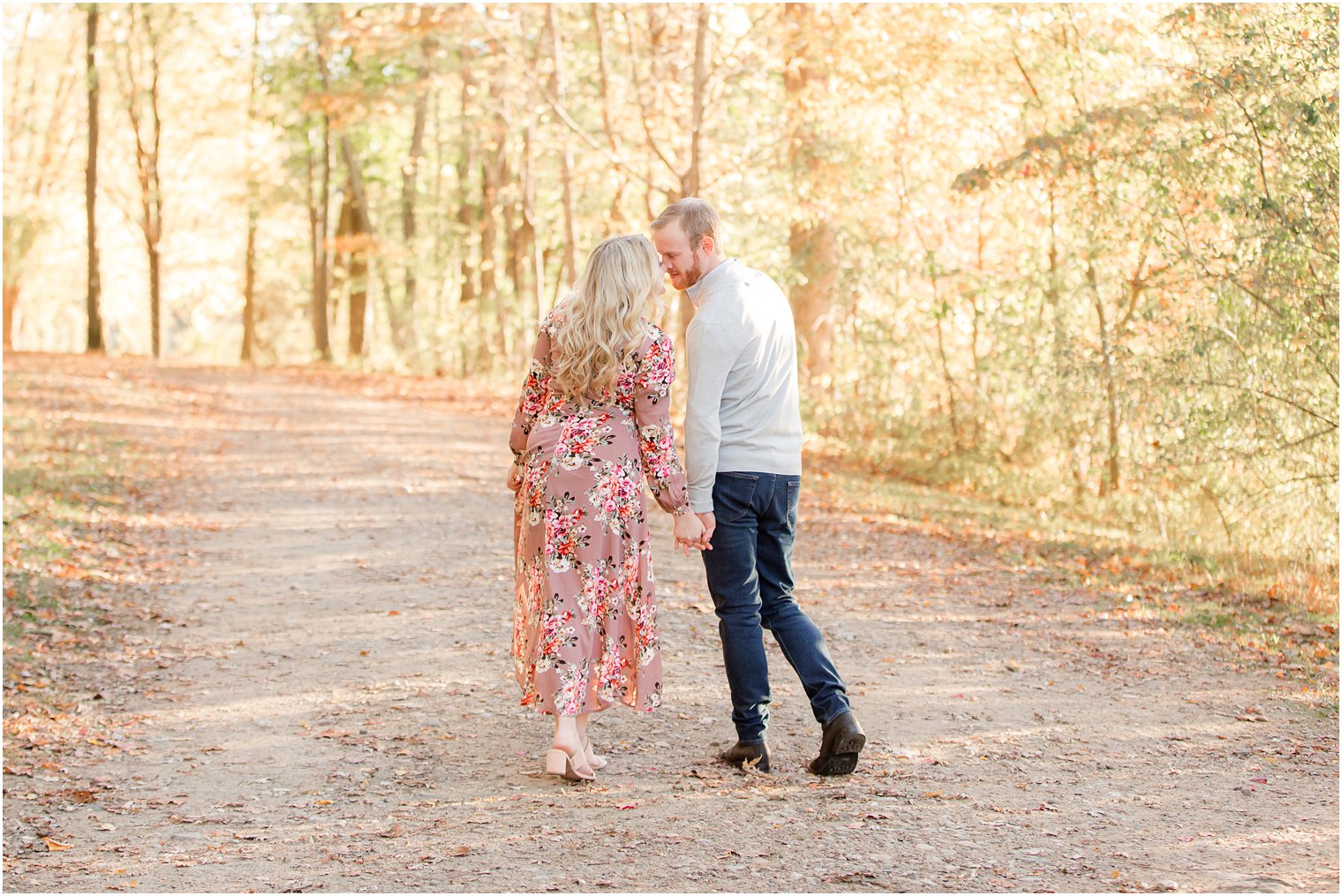 couple kisses while walking up pathway at Ramapo Reservation