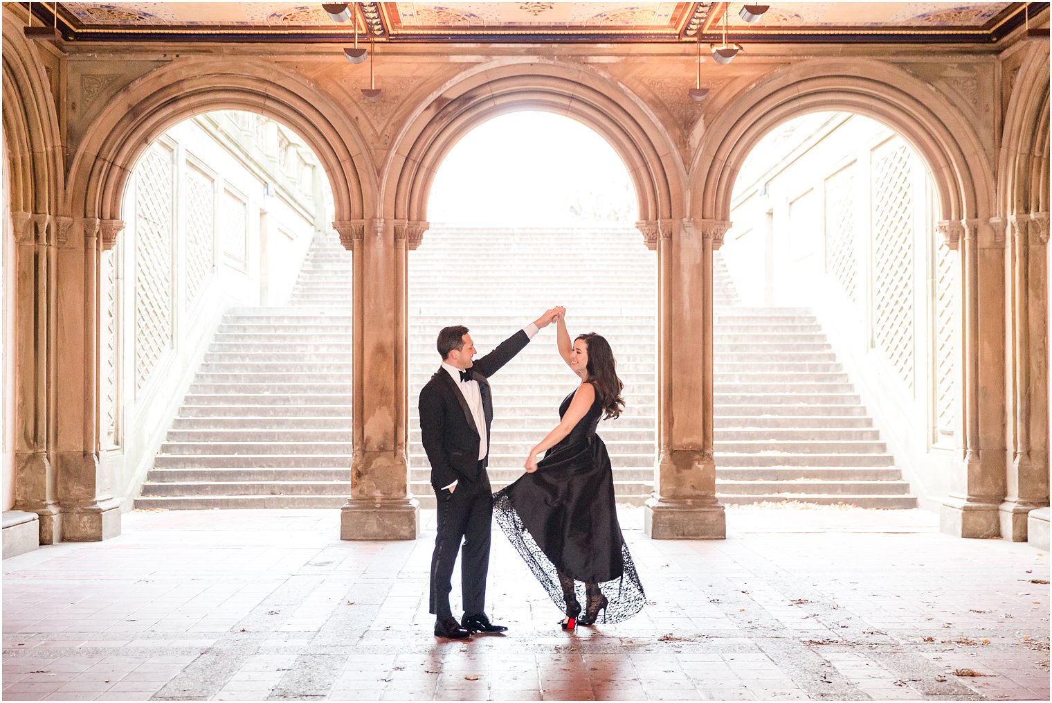 Engaged couple dancing at Bethesda Terrace in Central Park, NYC